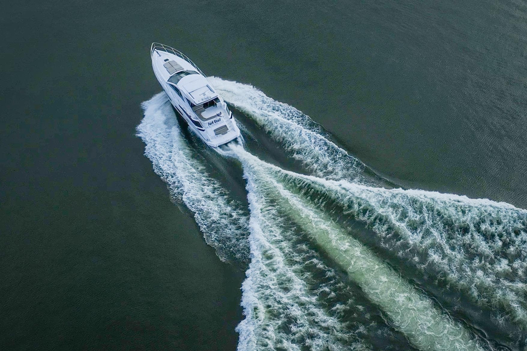 Aerial view of 2015 Regal 53 Sport Coupe yacht cruising on open water.