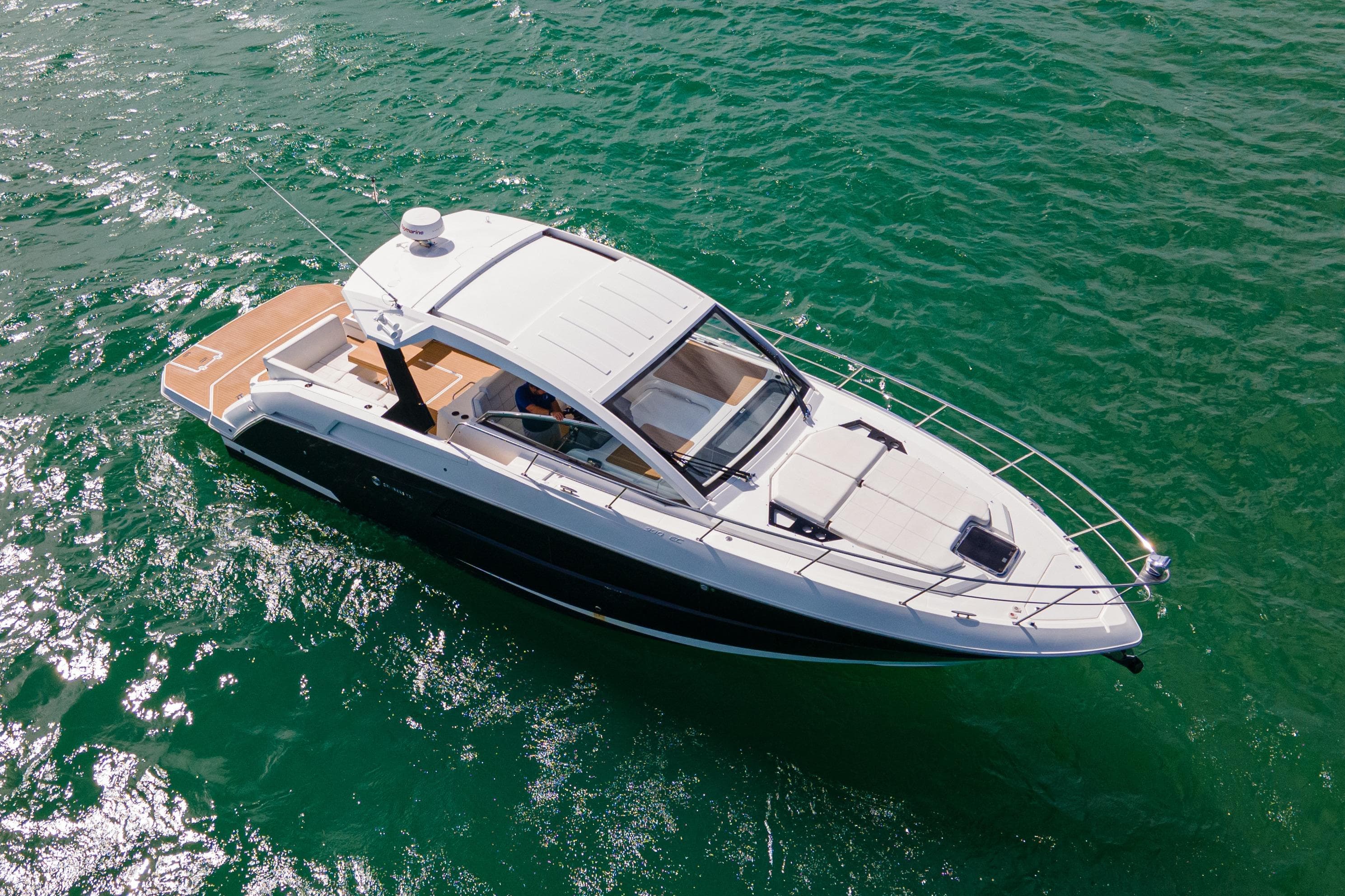 2018 Cruisers Yachts 390 Express Coupe on vibrant green water.