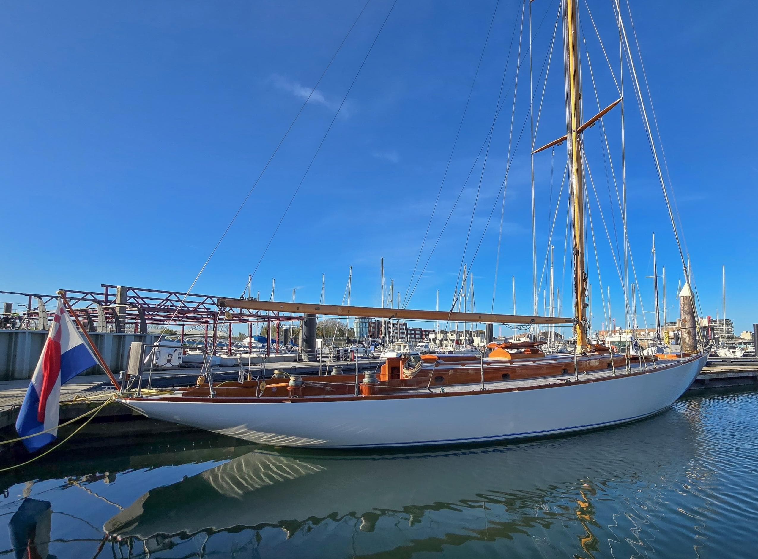 Sparkman & Stephens New York 32 yacht, 2009 model, docked in a marina under clear blue skies.