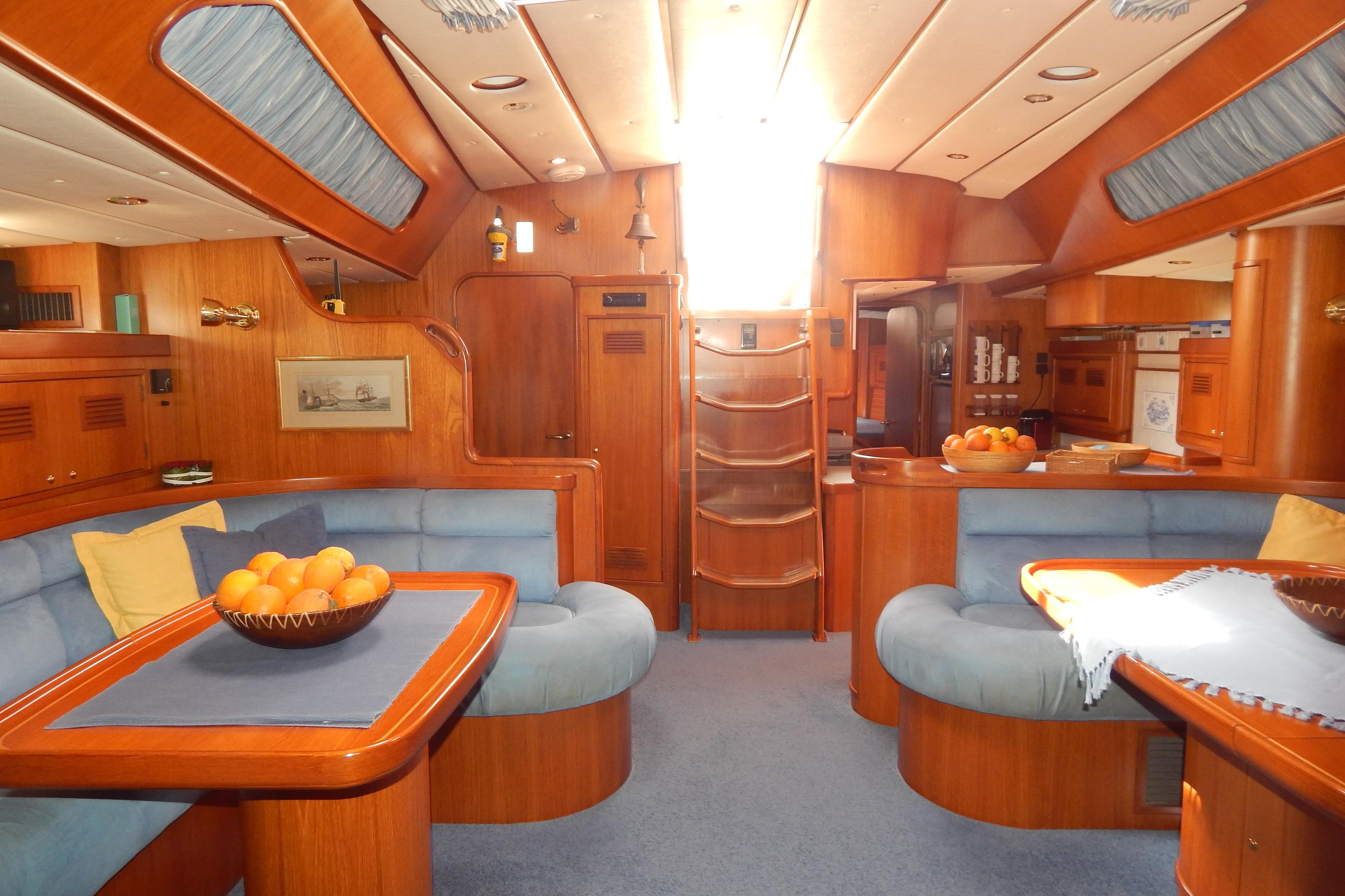 Luxurious 2003 Contest 60 C yacht interior with wooden finish and cozy seating area.