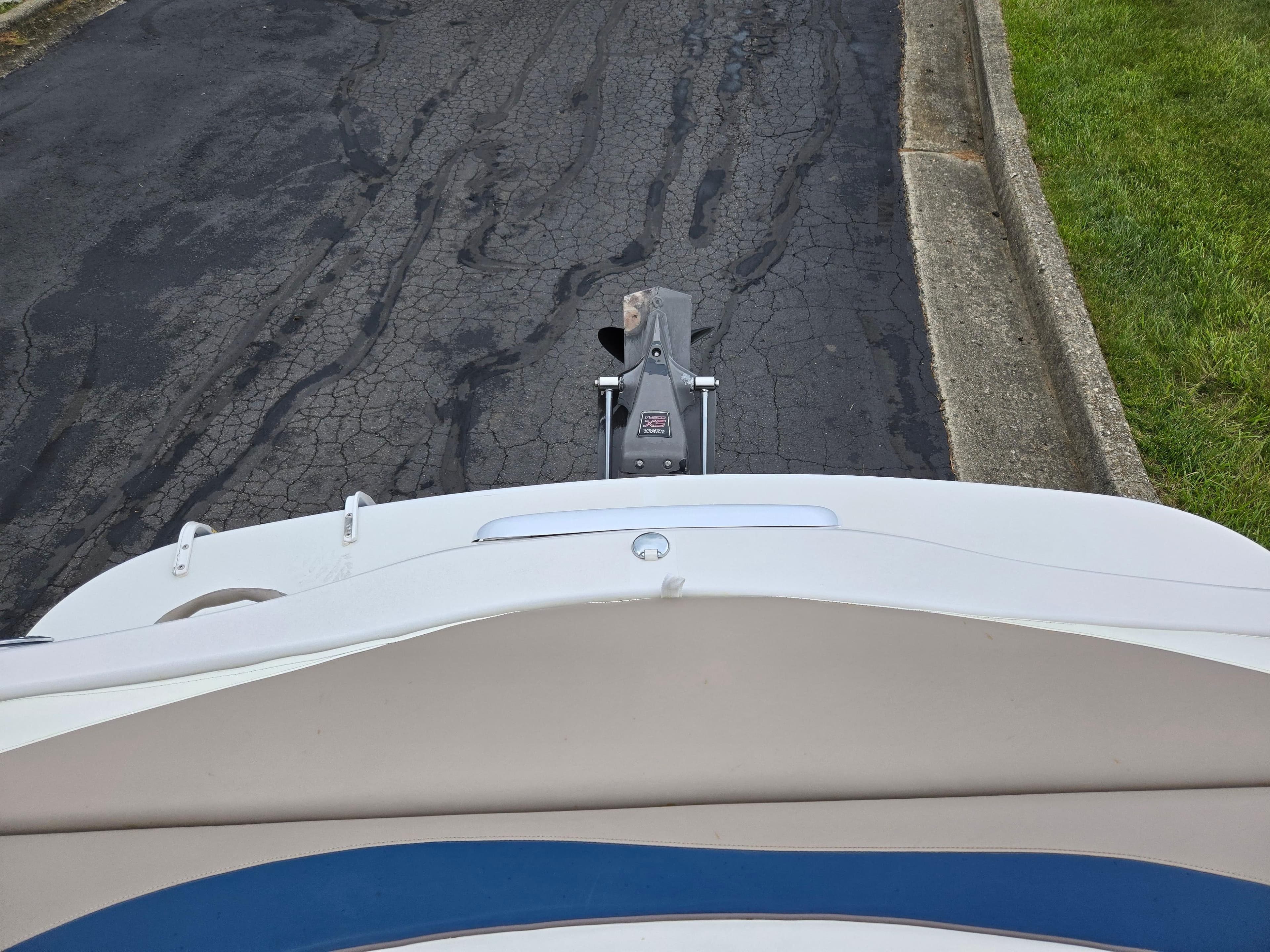1998 Four Winns Horizon RS RX boat on a paved road, viewed from above.