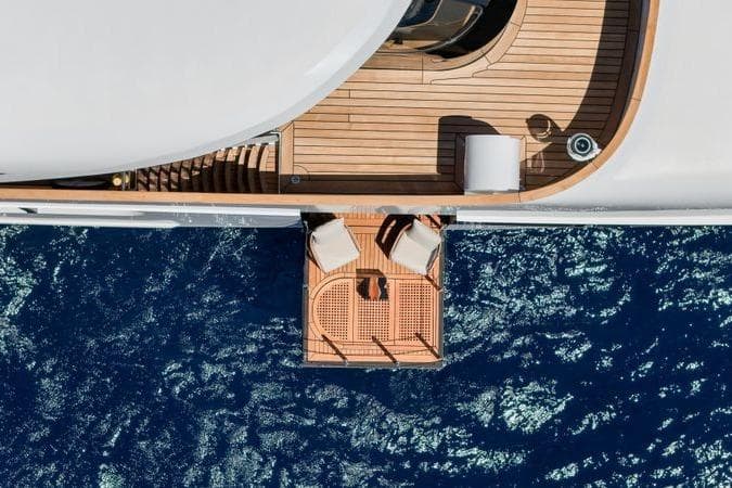 Aerial view of 1986 Elsflether Werft AG custom yacht deck over blue ocean.