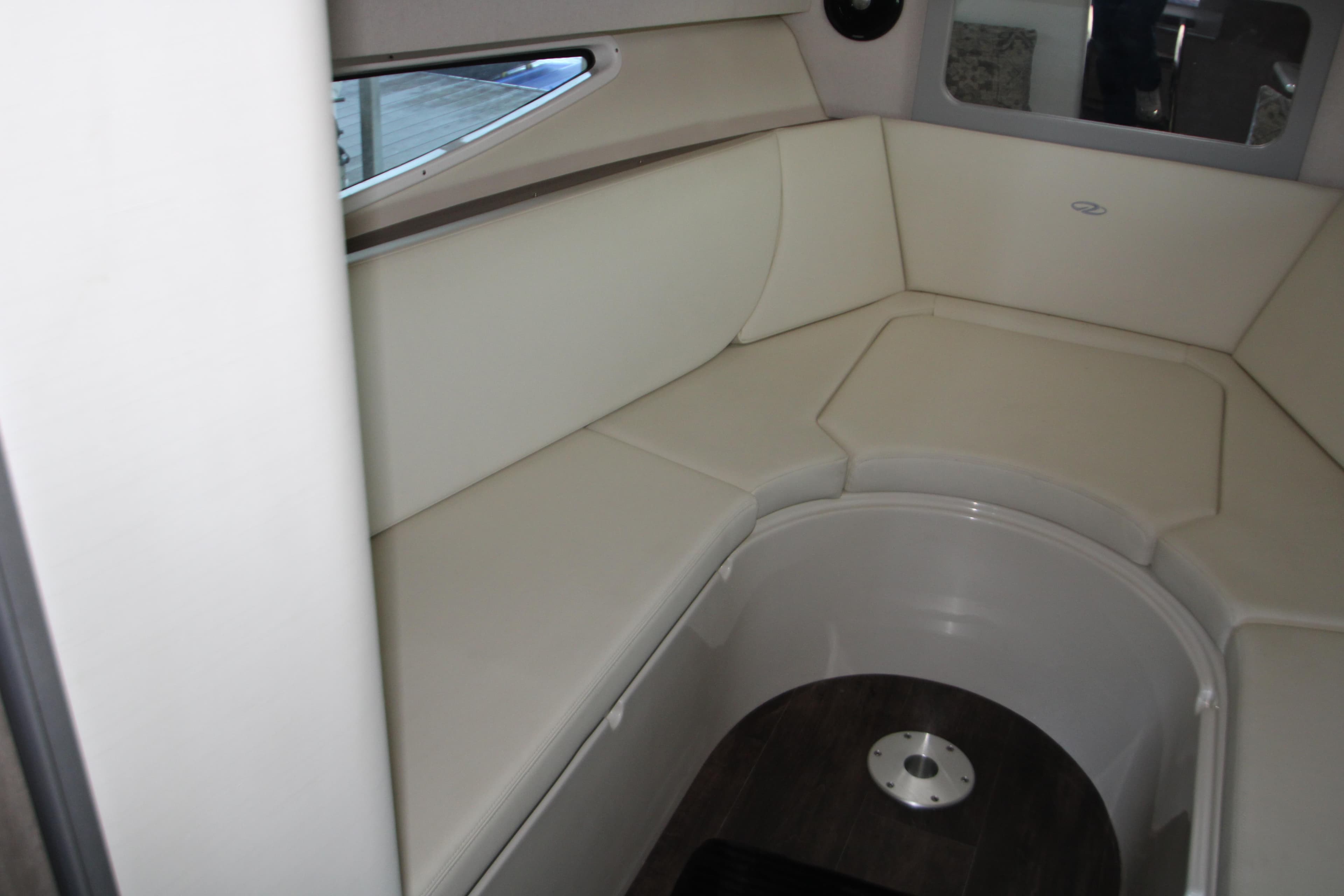 Interior seating area of 2022 Regal 28 Express boat, featuring cream upholstery.