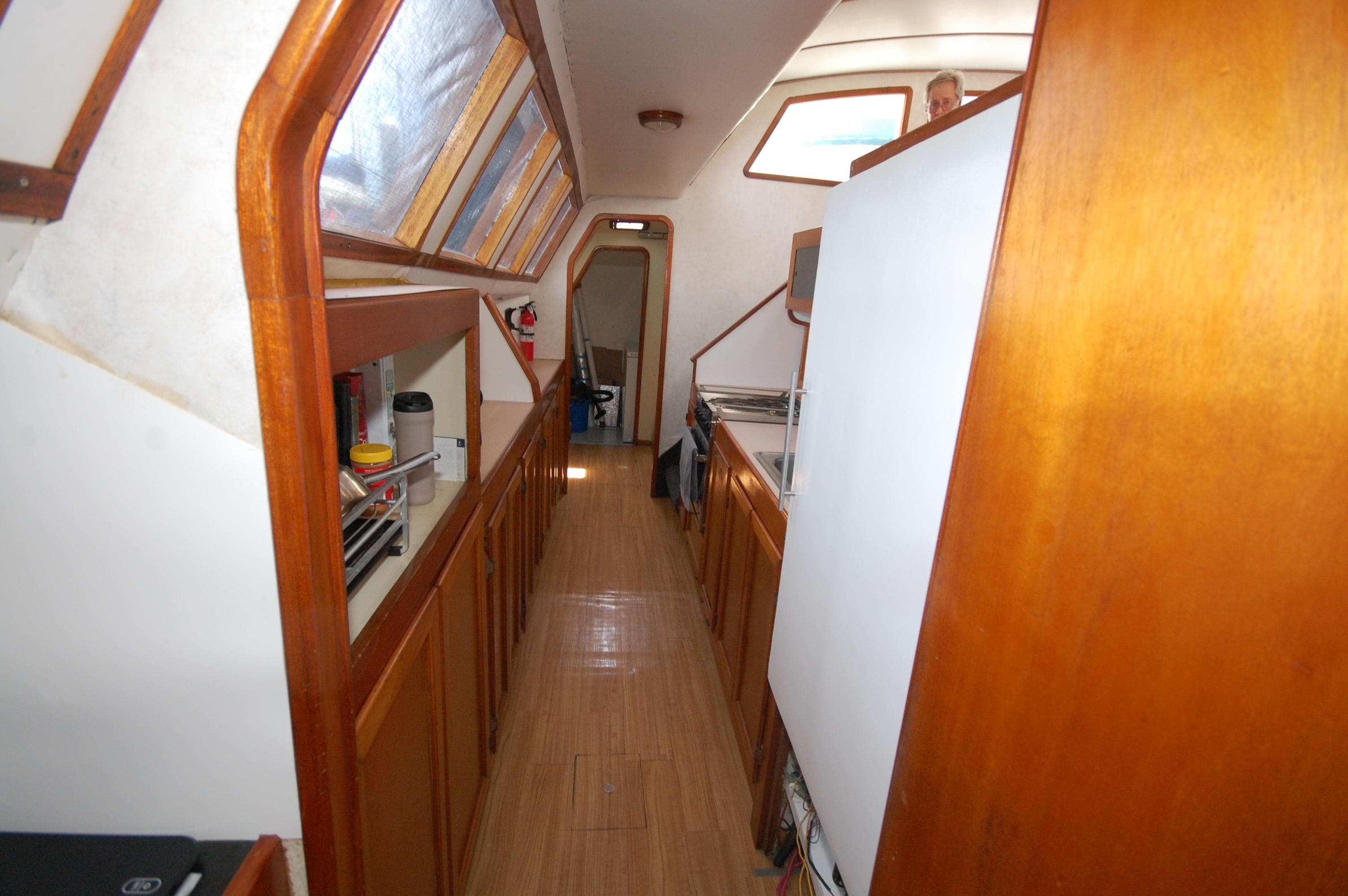 Interior of 2003 Leopard Morrelli & Melvin Catamaran with wooden cabinetry and skylights.