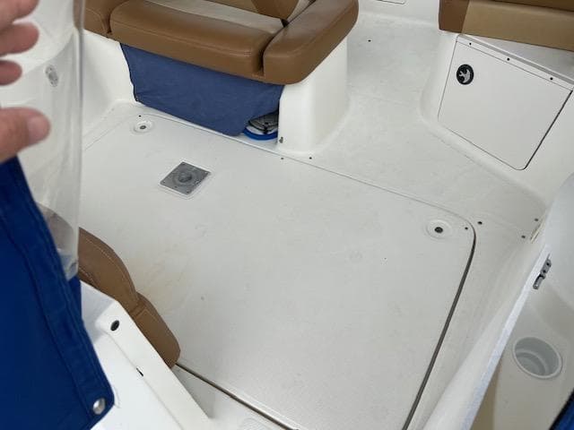 Interior view of a 2006 Bayliner 275 boat, featuring seating and storage compartments.