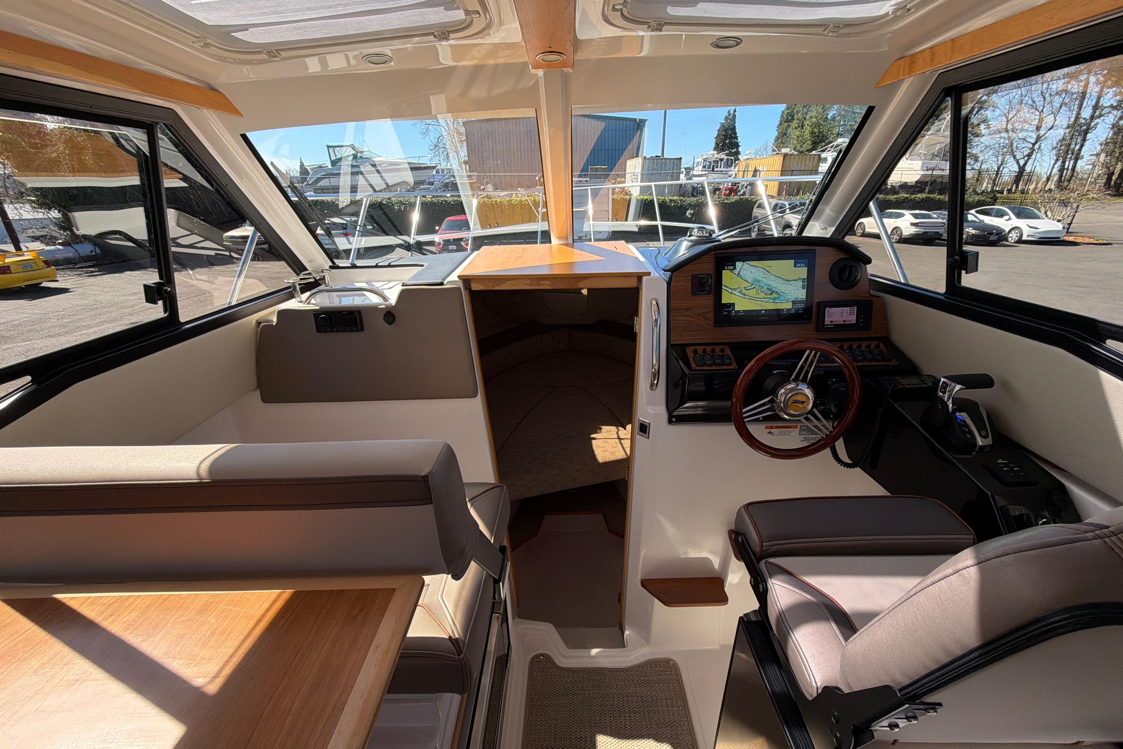 Interior of 2023 Cutwater C-248 Coupe boat with modern helm and seating area.