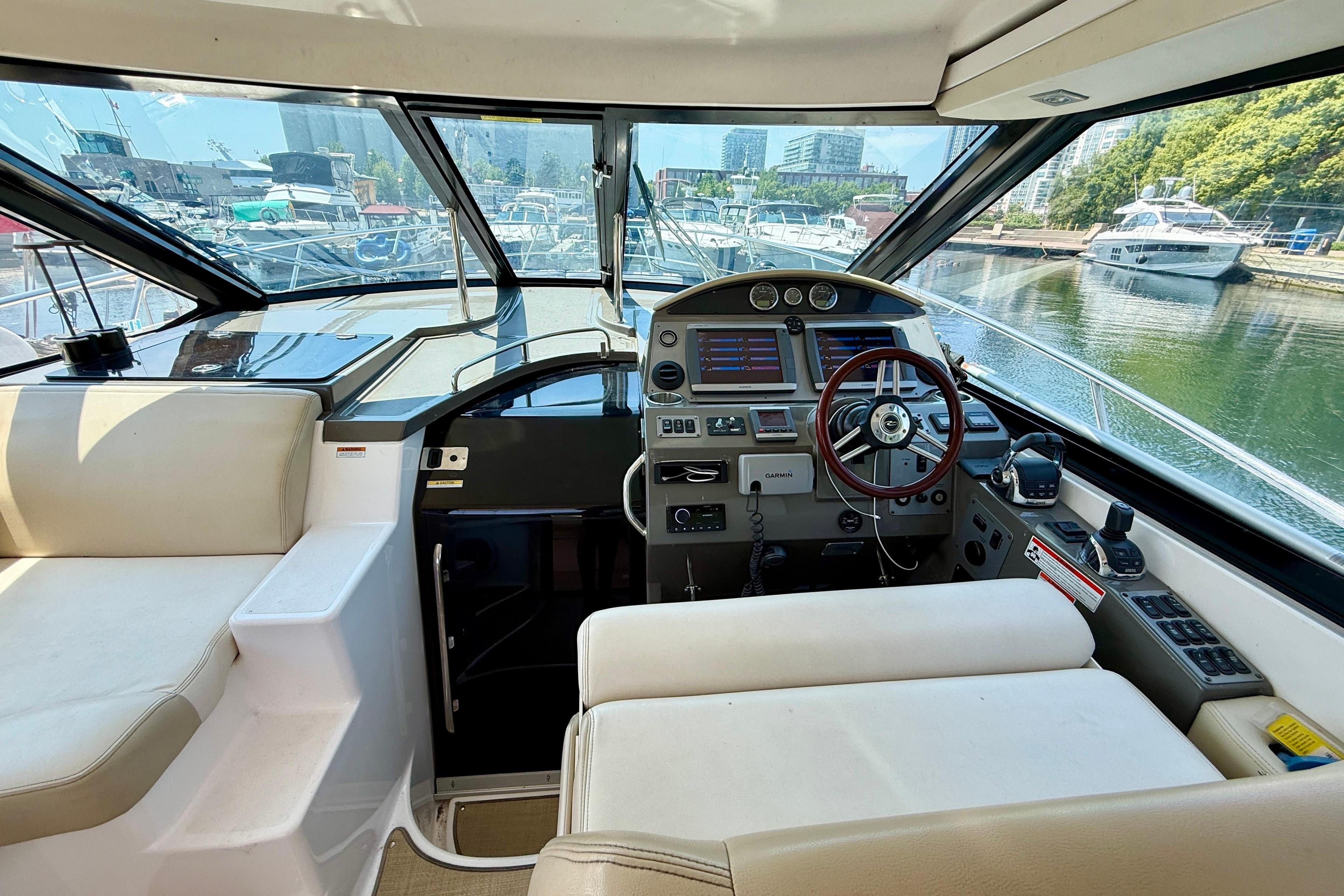 Interior view of 2012 Regal 42 Sport Coupe yacht cockpit with steering wheel and controls.