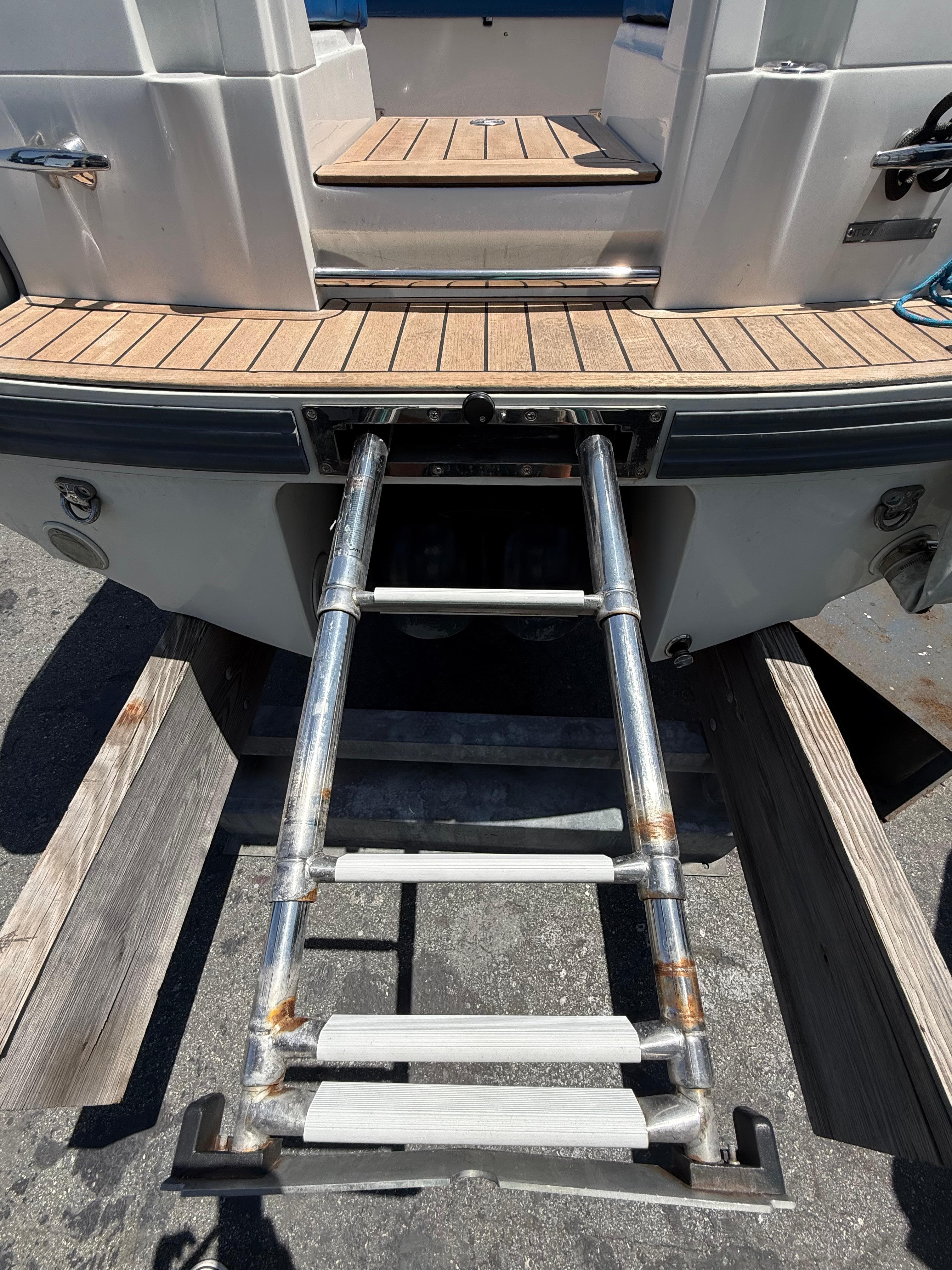 2022 Castoldi jet tender 14RB with extended boarding ladder on wooden deck.