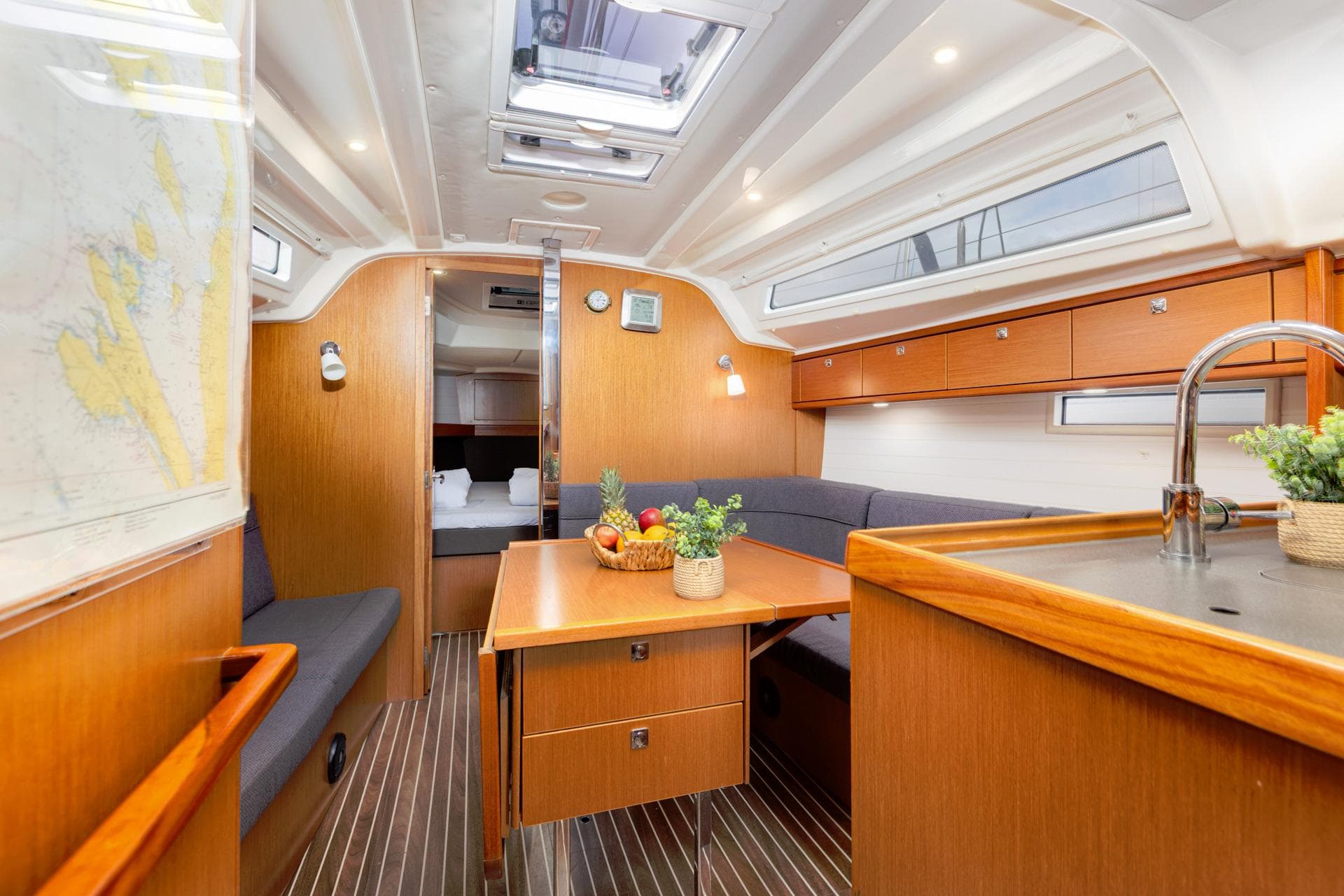 Interior of 2017 Bavaria 37 Cruiser yacht with modern wood finish and cozy seating.