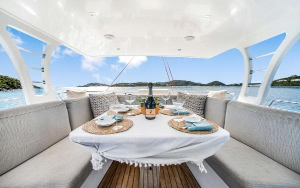 Luxurious Sunreef 60 LOFT yacht dining area with elegant table setting, ocean view, 2016 model.