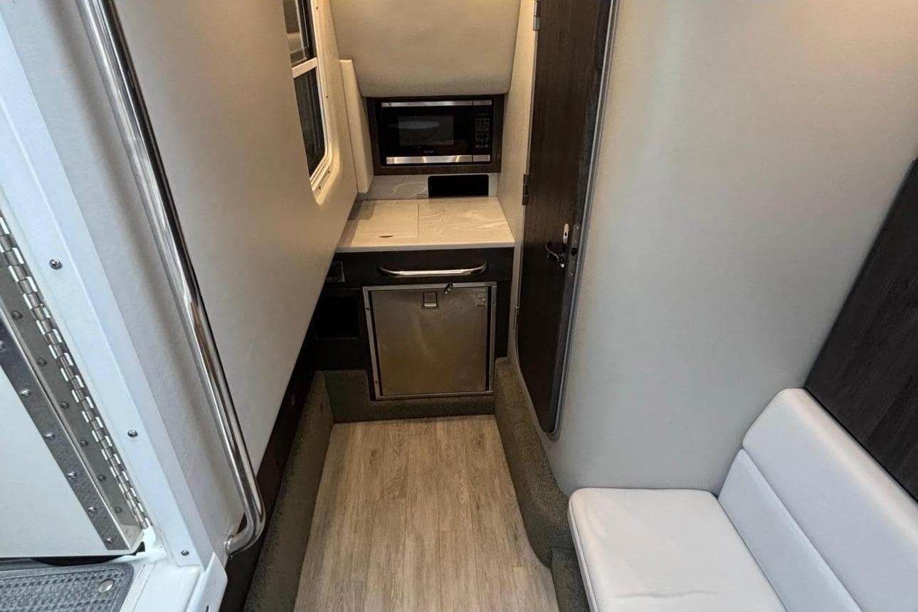 Interior of 2022 Formula 350 Crossover Bowrider OB, featuring compact kitchen area.