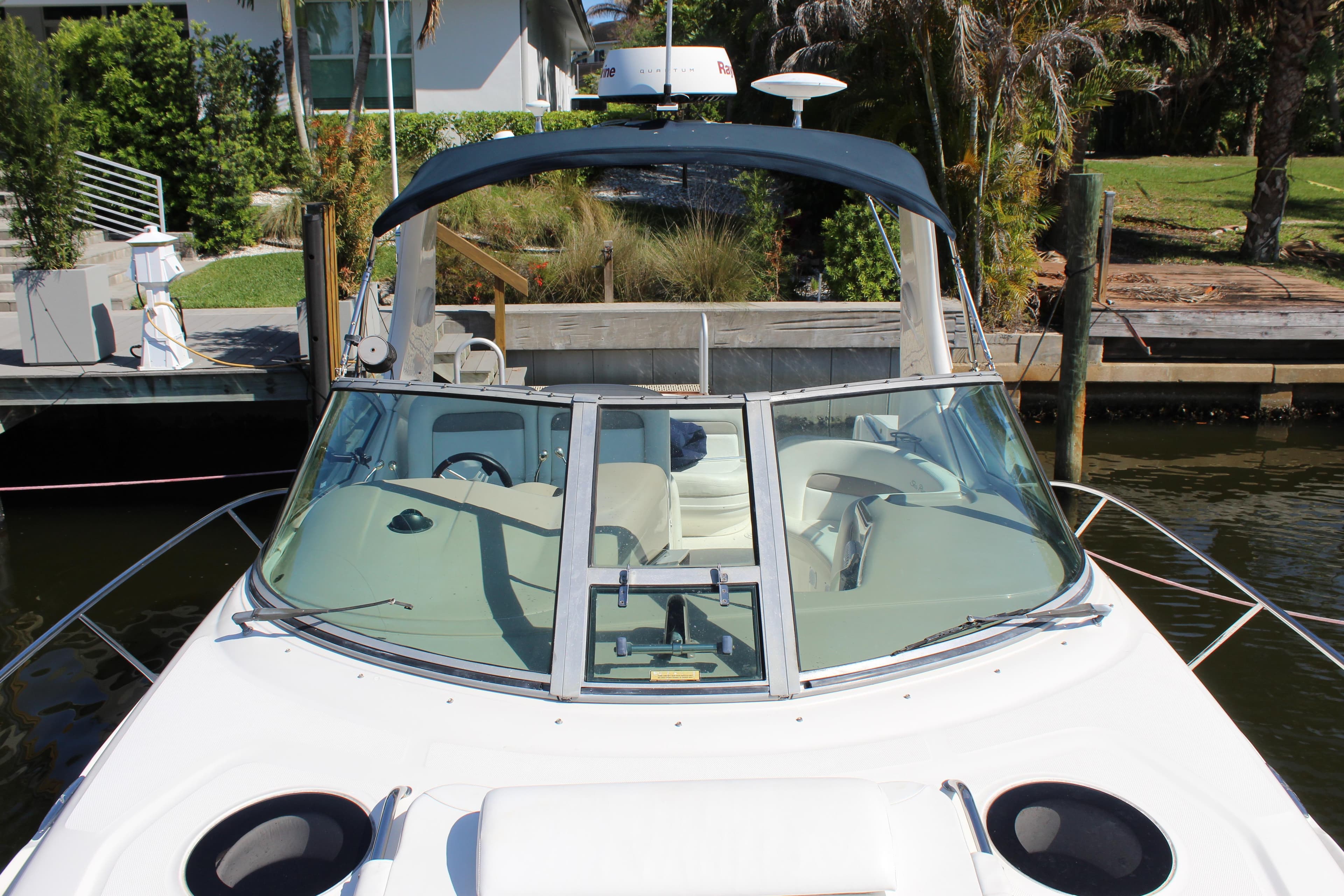 2005 Sea Ray Sundancer 320 docked, showcasing sleek design and spacious cockpit.