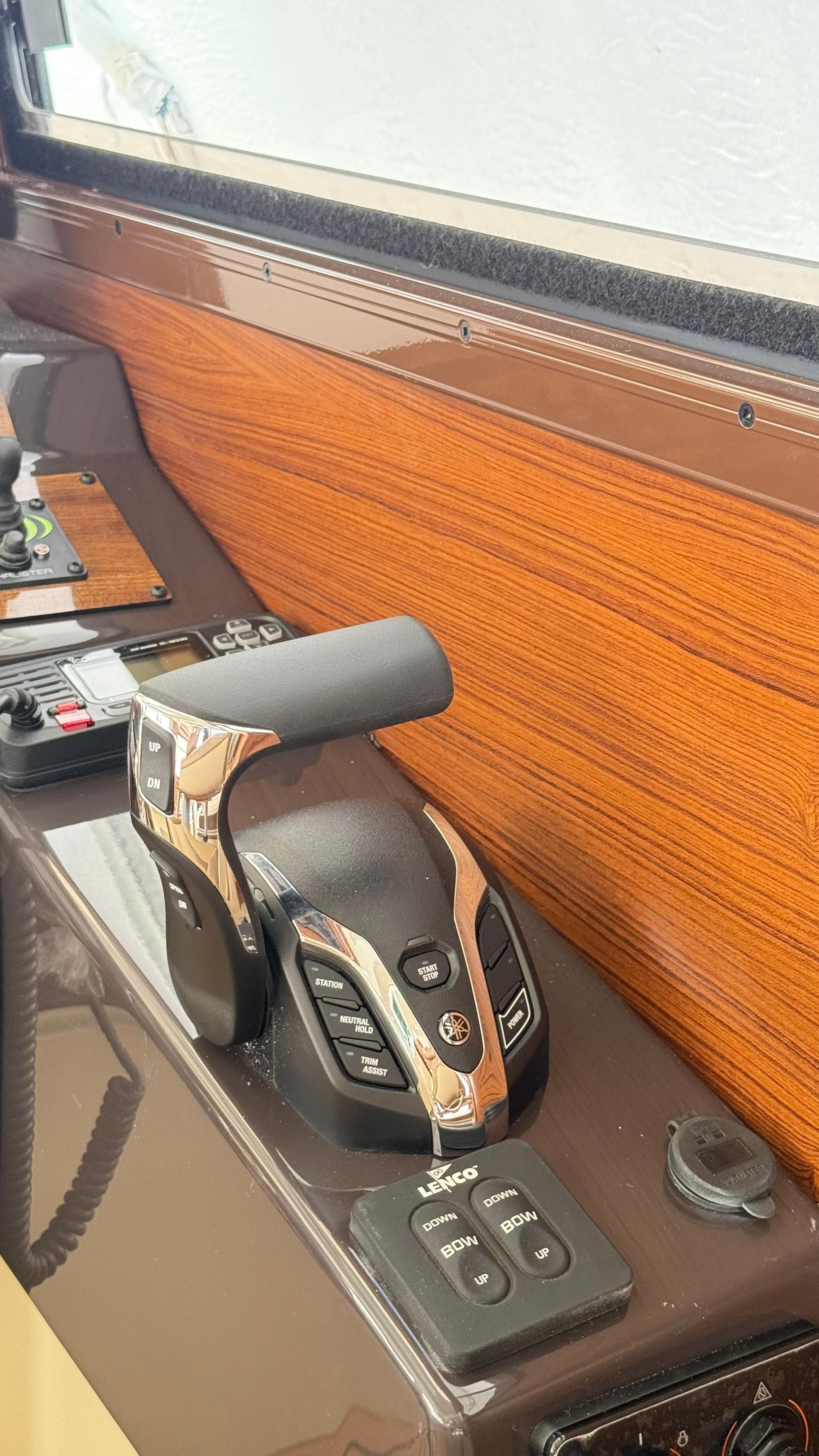 Control panel of 2026 Ranger Tugs R-27 with throttle and trim controls.