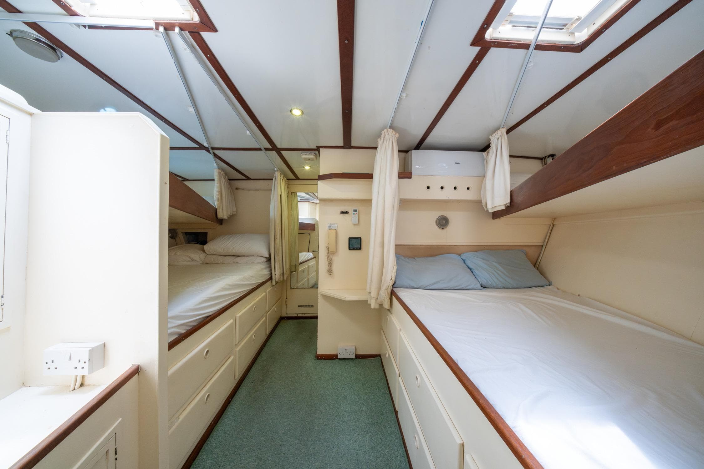 Cozy 1972 Custom Siccna yacht cabin with bunk beds and soft lighting.