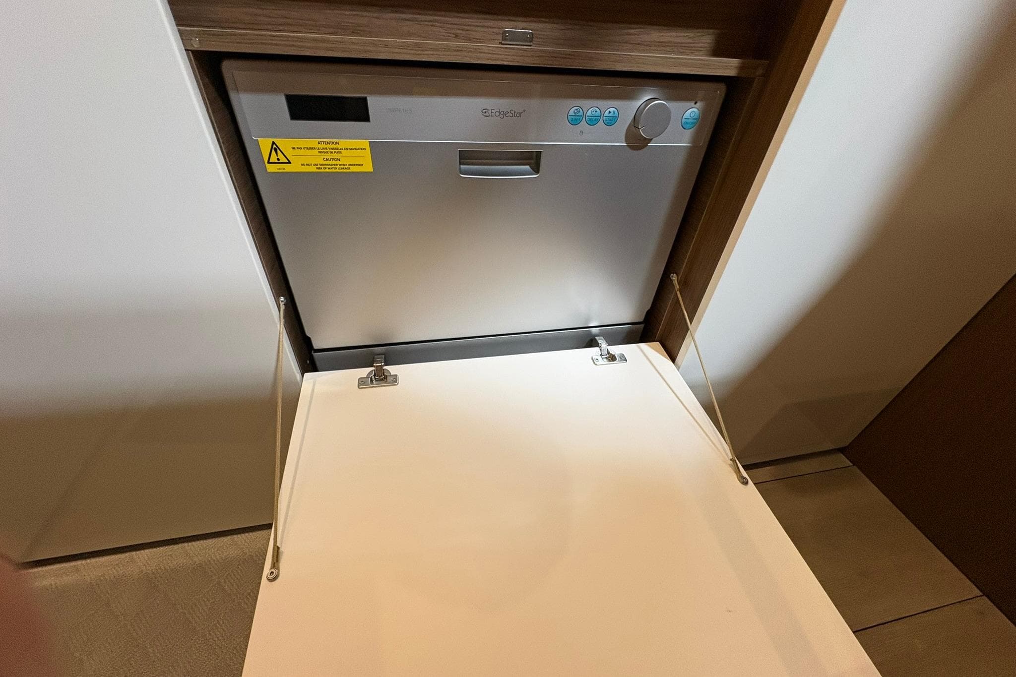 Built-in dishwasher on Jeanneau Leader 46 yacht, 2022 model, with open door.