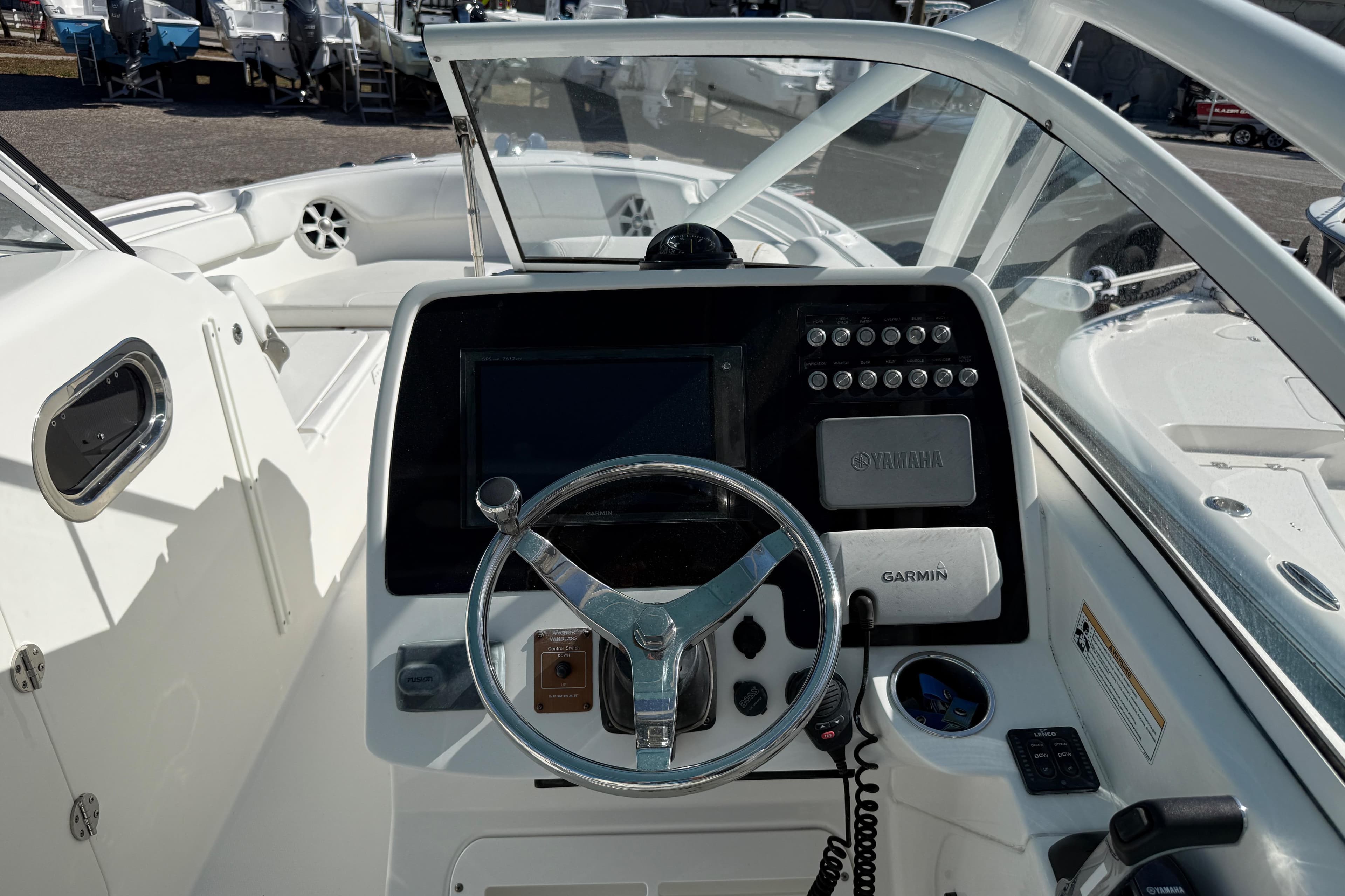 2017 Edgewater 248CX Crossover boat dashboard with steering wheel and navigation controls.