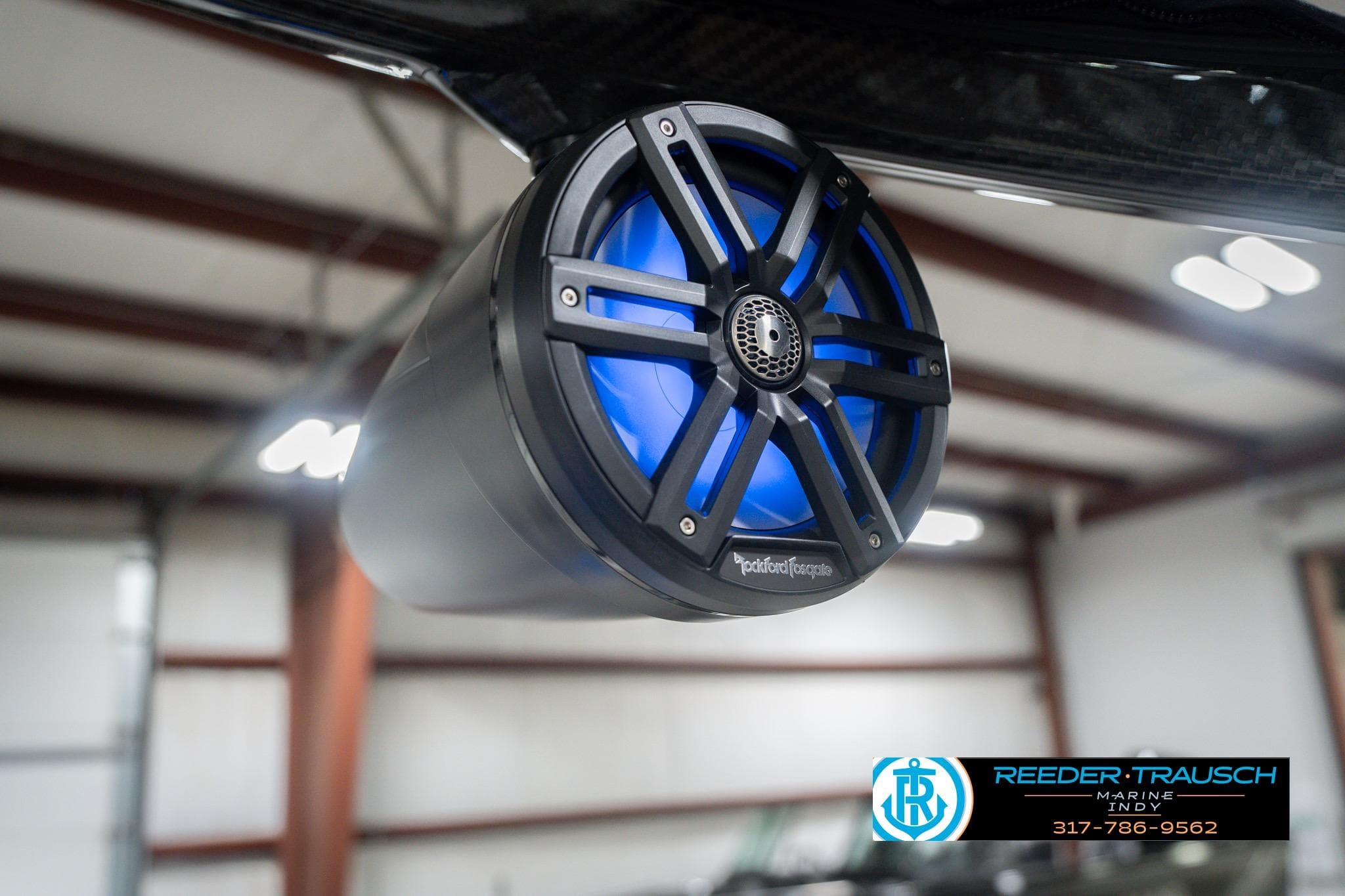 2026 Bennington 24 MCSB with Rockford Fosgate speaker, blue LED lighting, in a showroom.