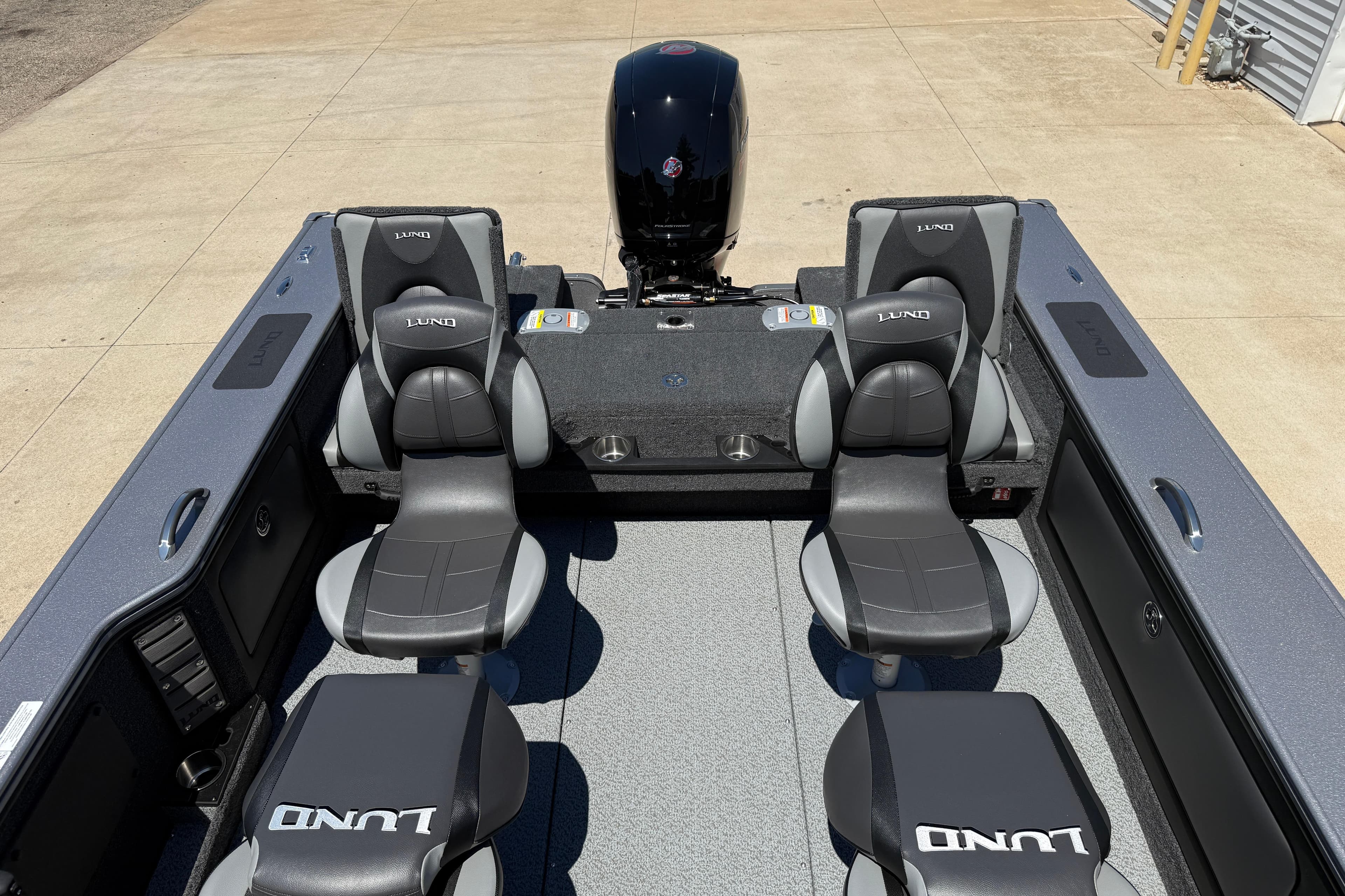 2026 Lund 1875 Pro-V boat interior with four seats and an outboard motor.