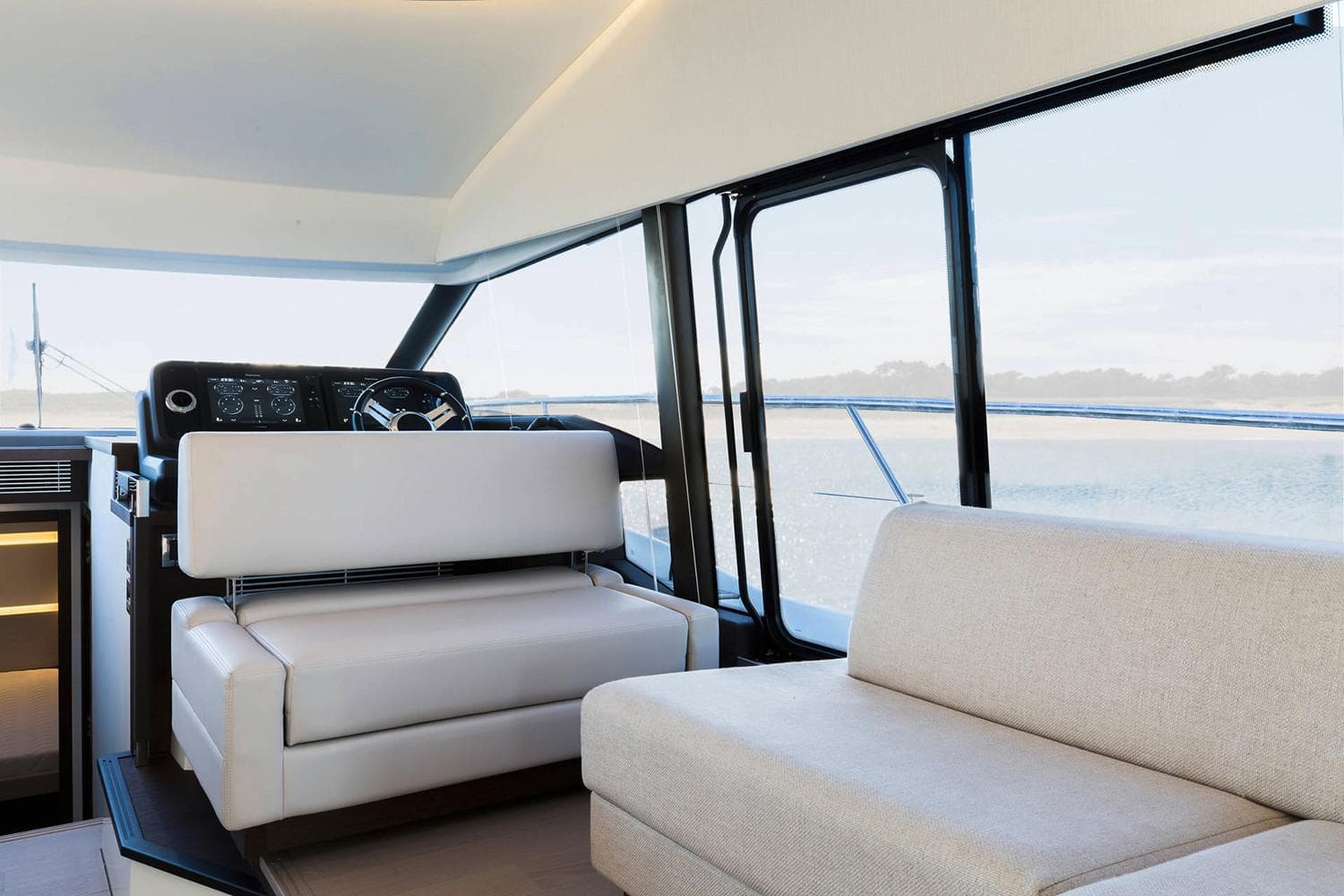 Manufacturer Provided Image: Interior of 2022 Prestige 520 yacht with modern seating and panoramic windows.