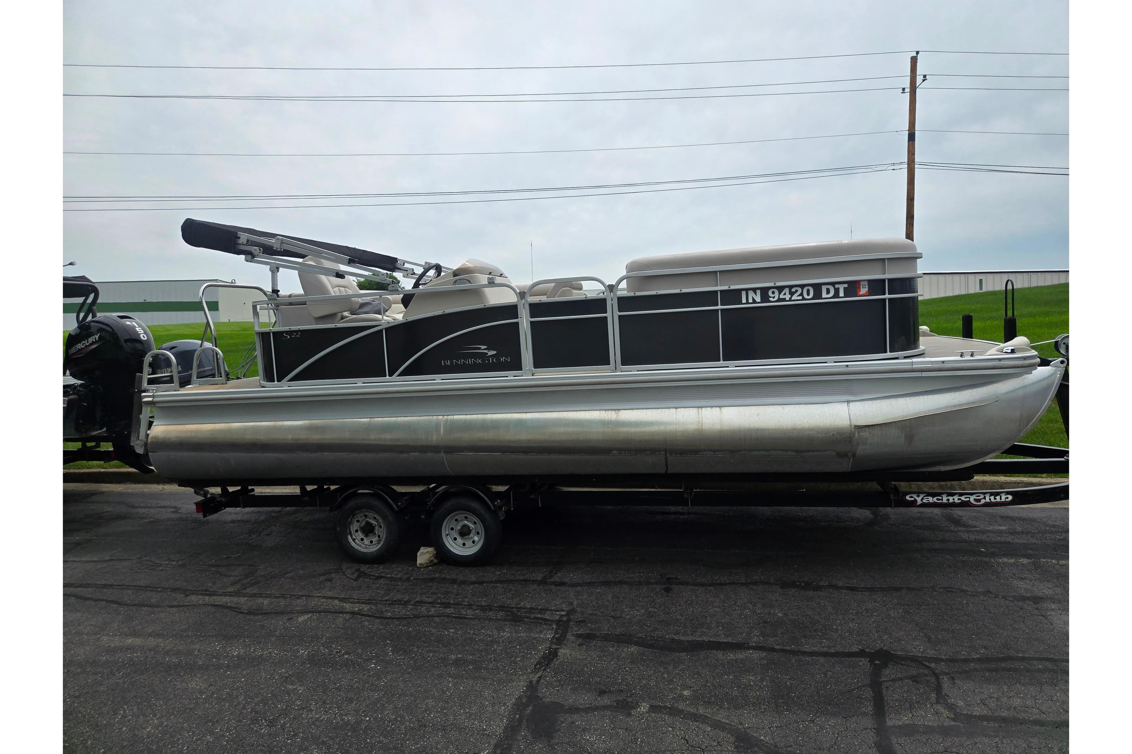 2014 Bennington 22 SLX pontoon boat on trailer, side view.