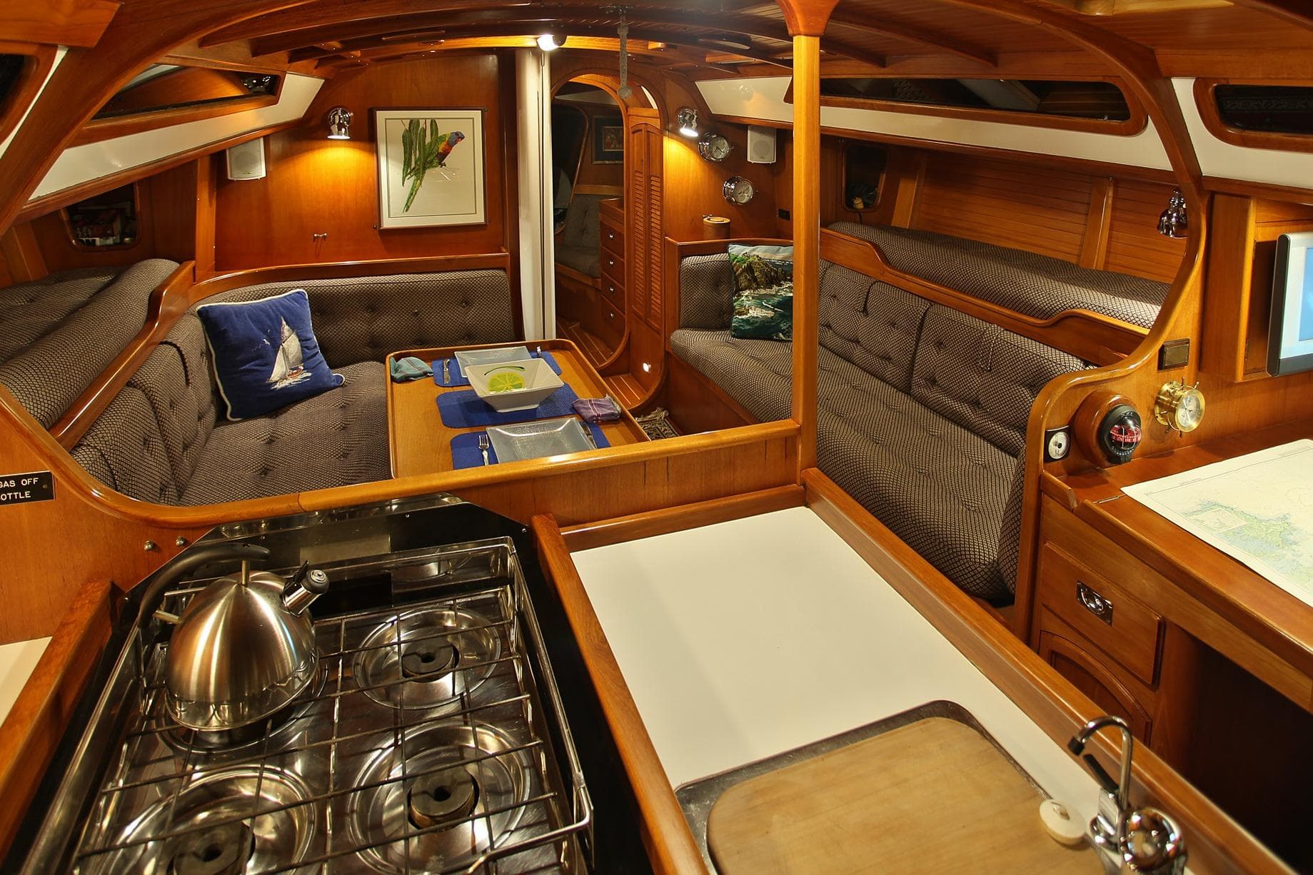 Luxurious 1986 Davidson 47 yacht interior with cozy seating and modern kitchen amenities.