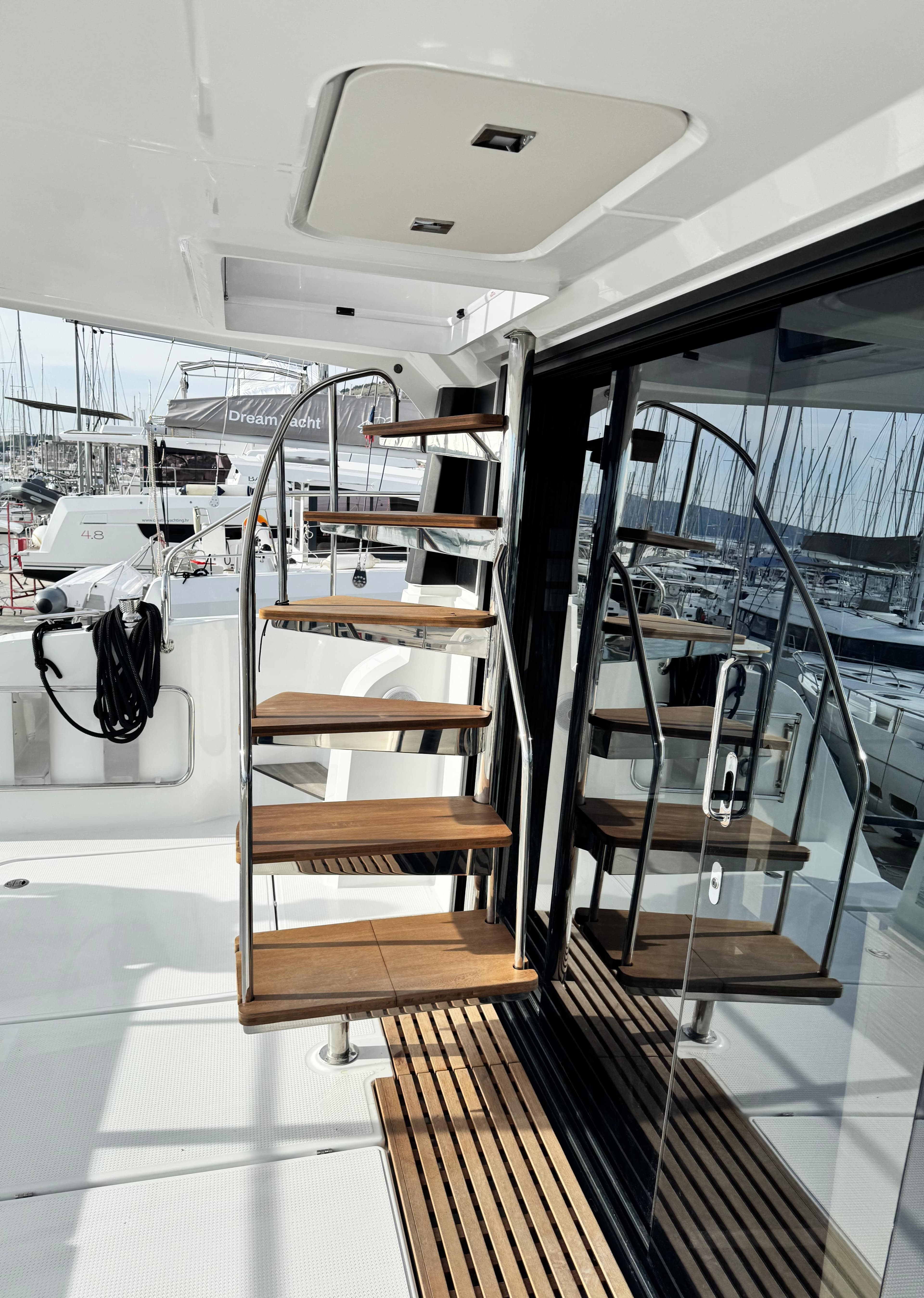 Staircase on 2025 Fountaine Pajot MY5 yacht, featuring sleek design and wooden steps.