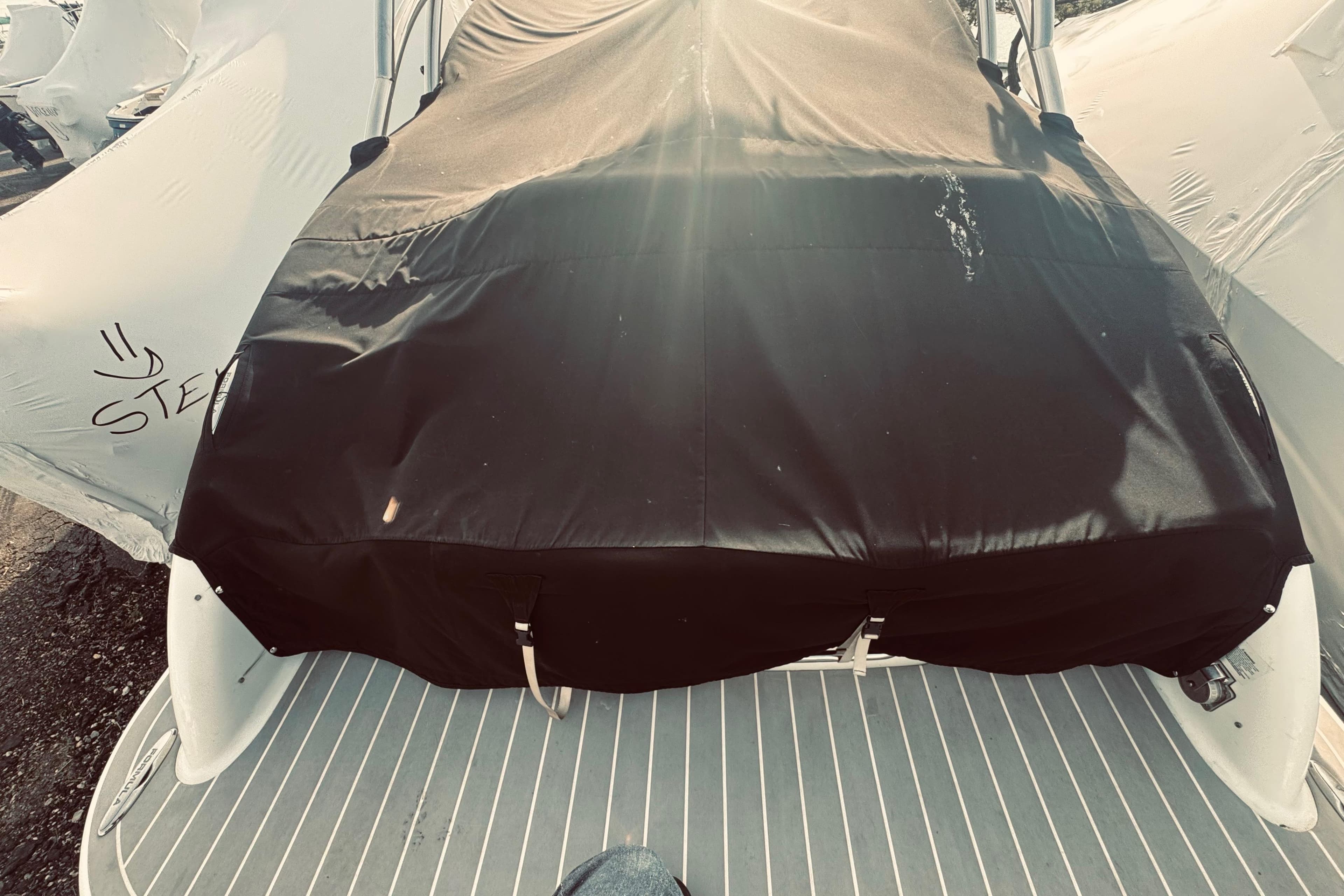 2019 Formula 310 FX Bowrider covered, docked with protective tarp.