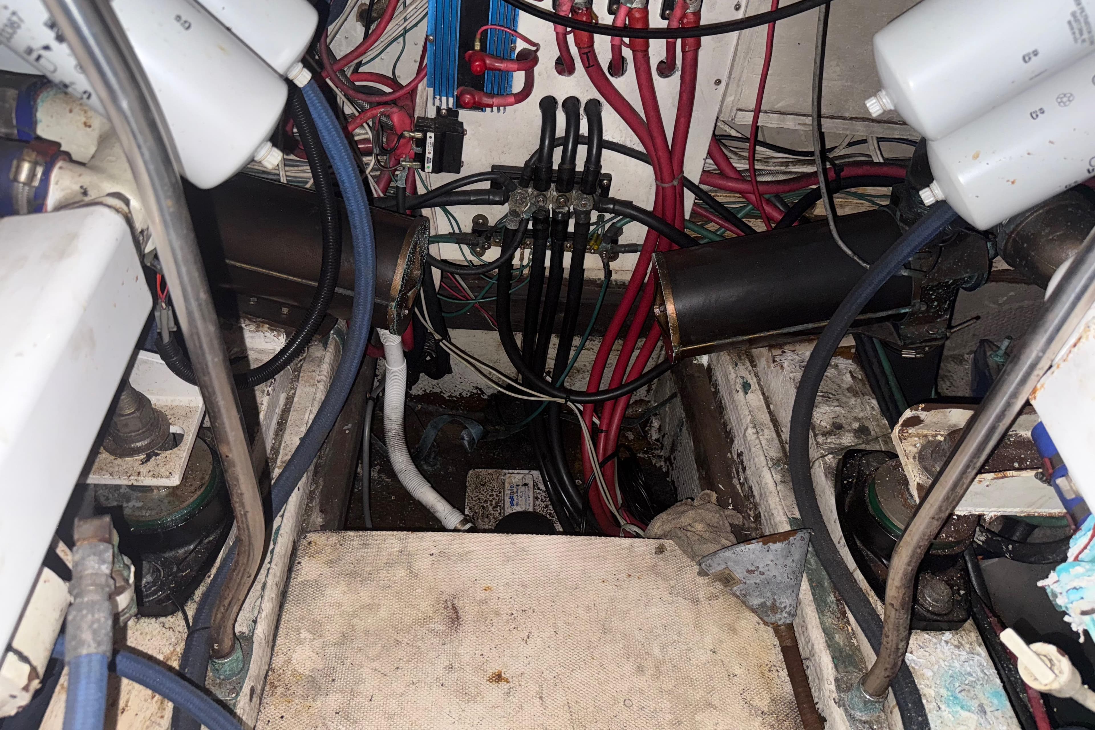 Engine room of a 1974 Pacemaker 48 Sportfisherman with visible wiring and components.