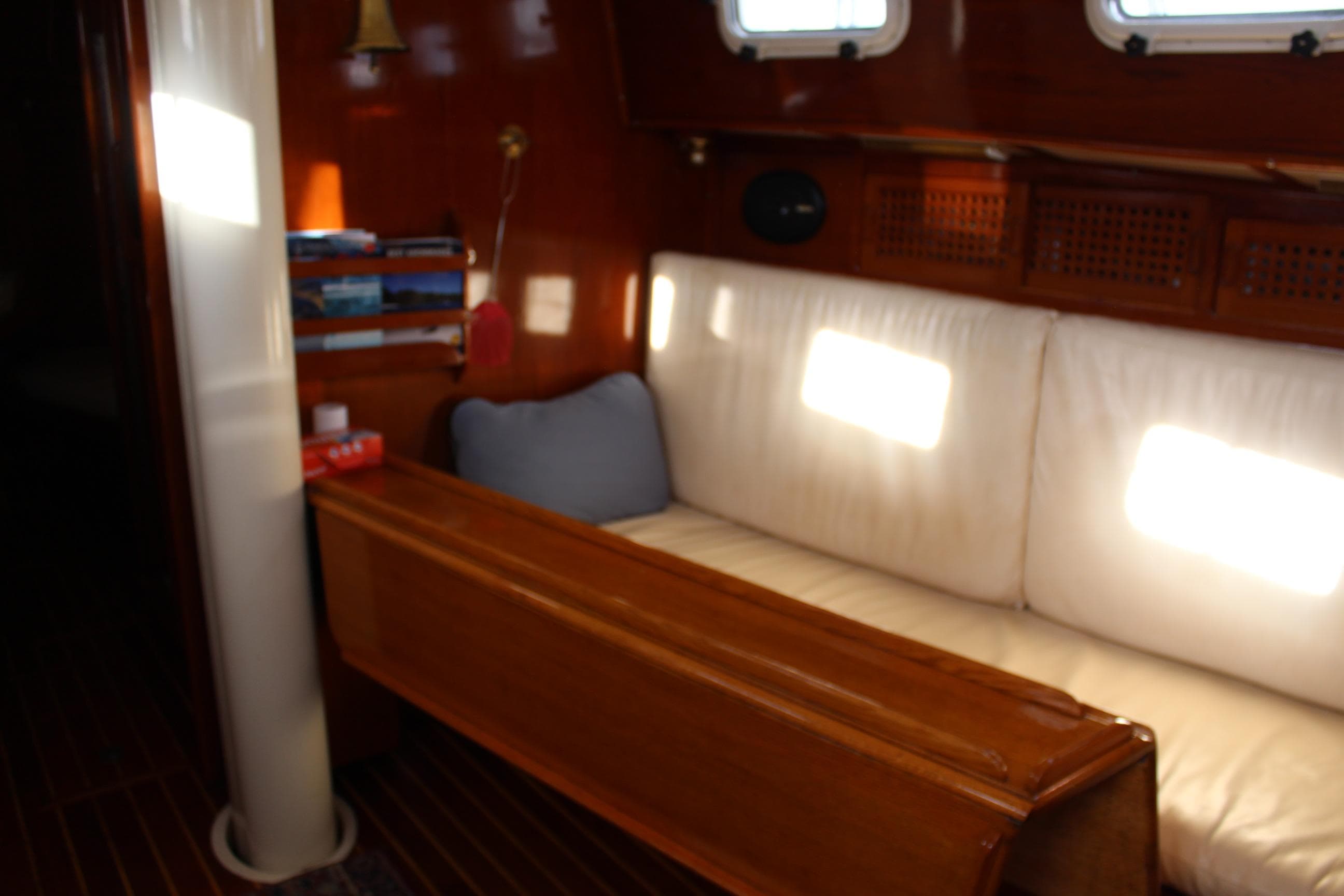 Interior of 1979 Spencer Yachts 53, featuring wooden paneling and cushioned seating.