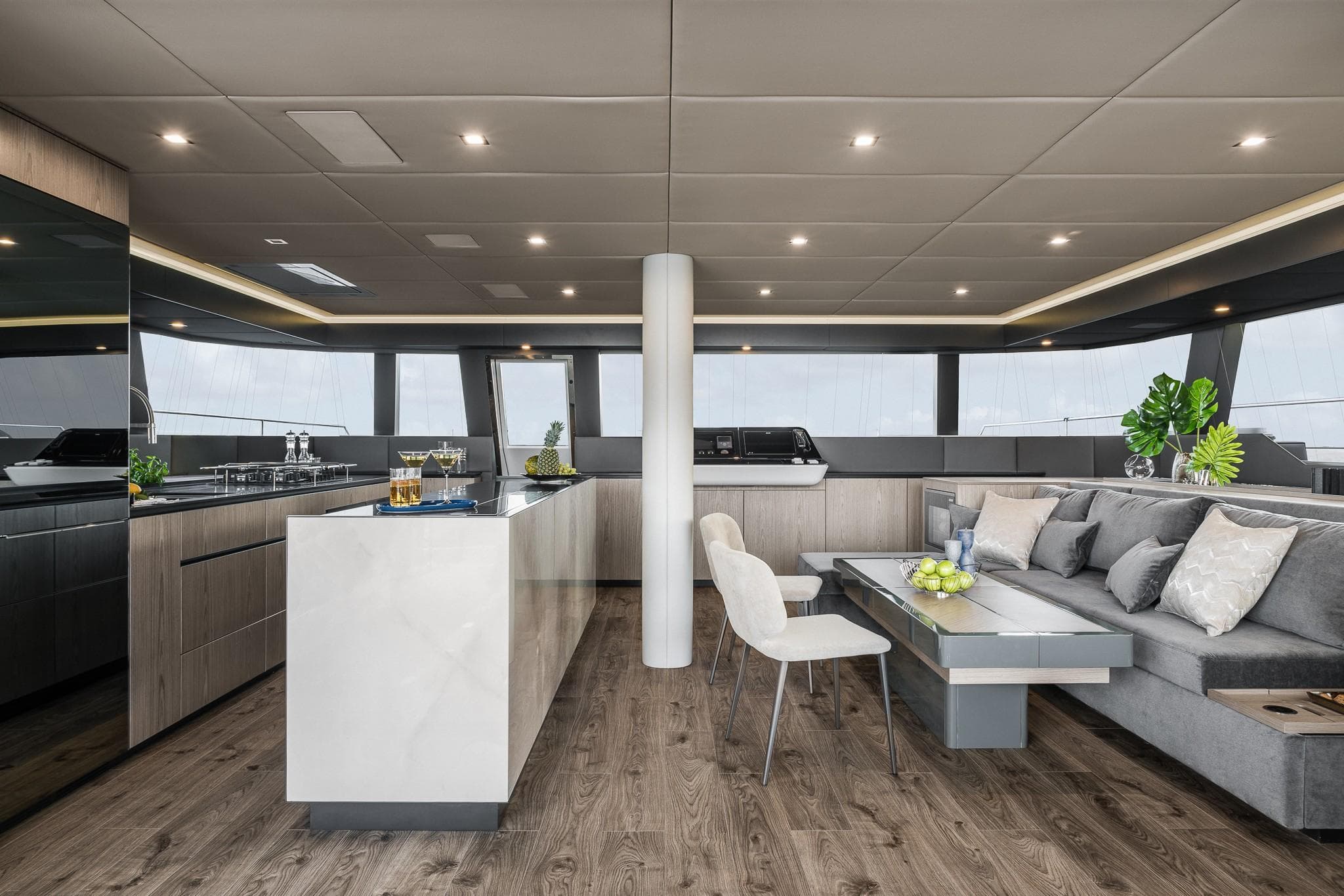Luxurious interior of 2026 Sunreef 60 yacht with modern kitchen and elegant seating area.