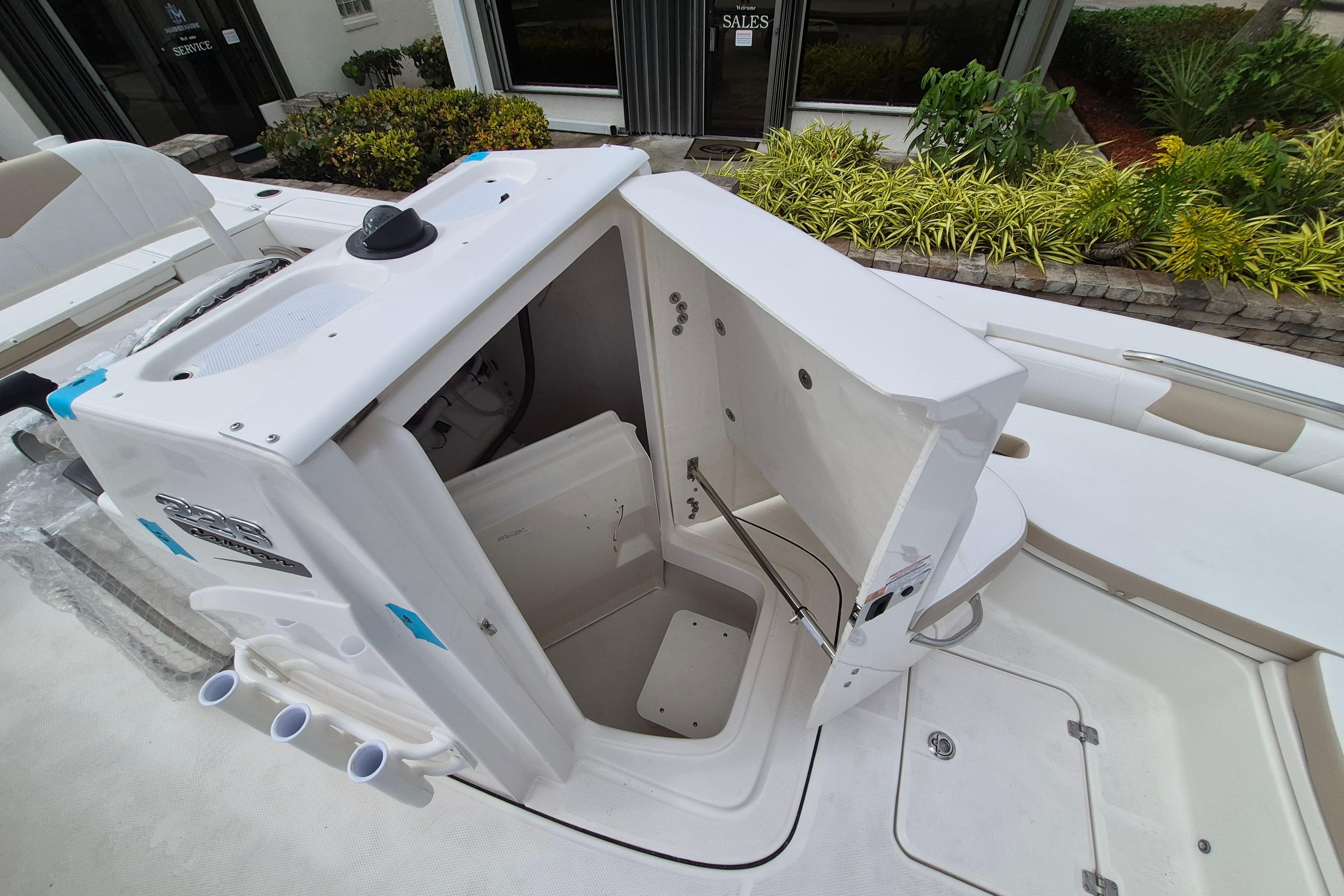 2026 Robalo 226 Cayman boat interior with open storage compartment and seating area.