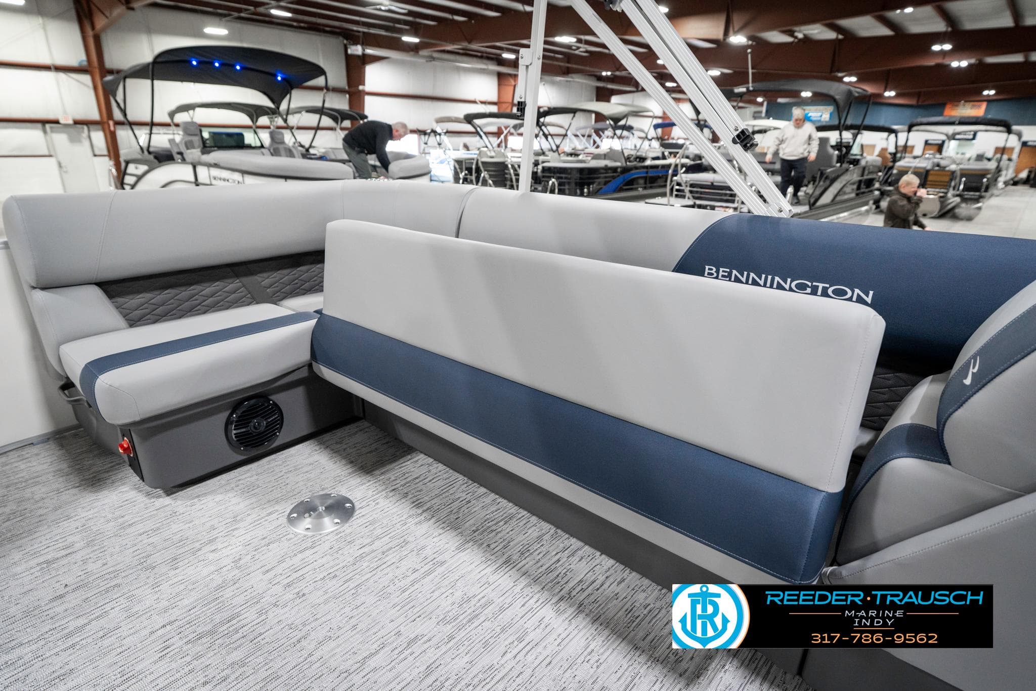2025 Bennington 22 SLS pontoon boat interior with gray and blue seating.