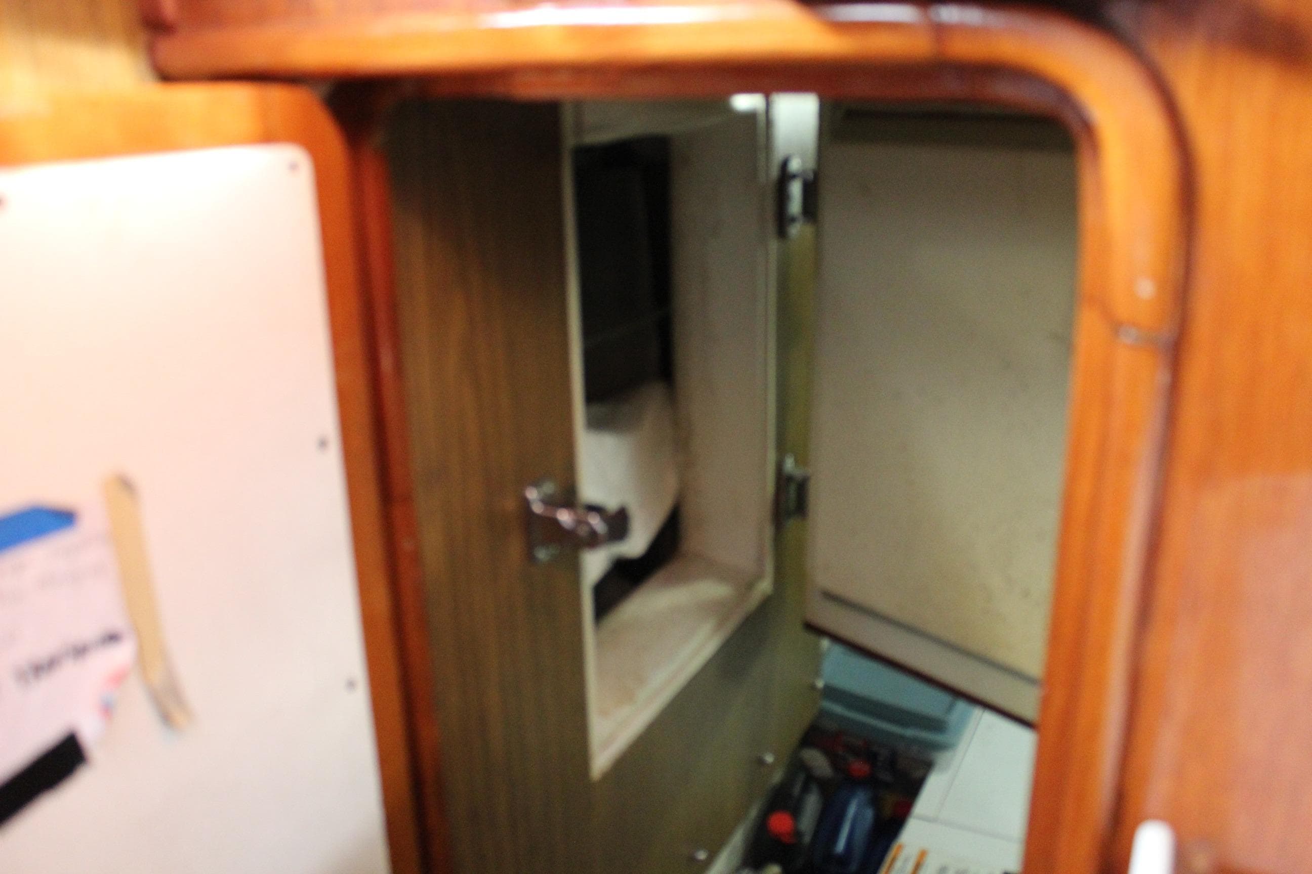 Interior view of a 1979 Spencer Yachts 53, featuring wooden cabinetry and storage compartments.