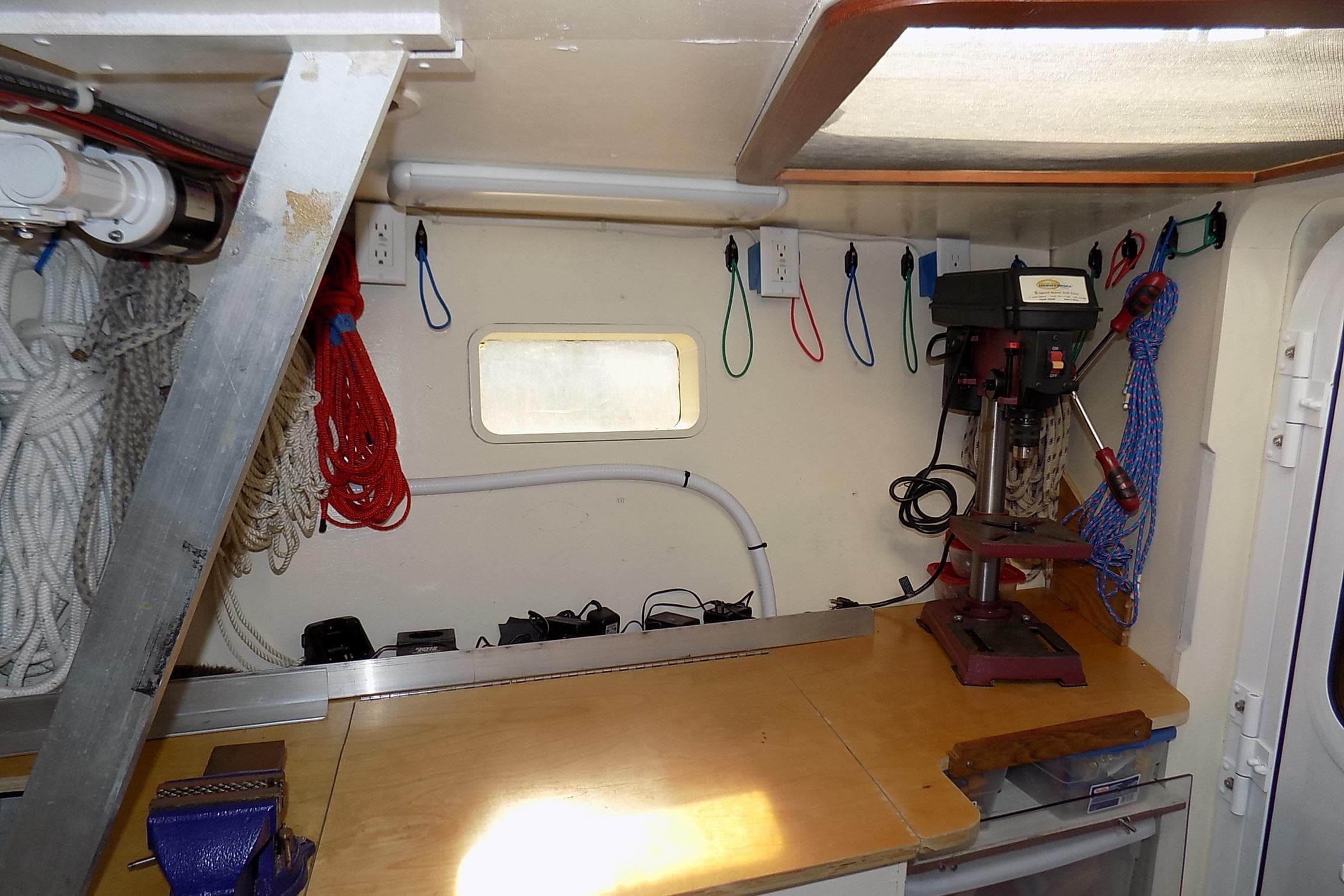 Workshop interior of 2014 Custom Aluminum Expedition with tools and ropes organized neatly.