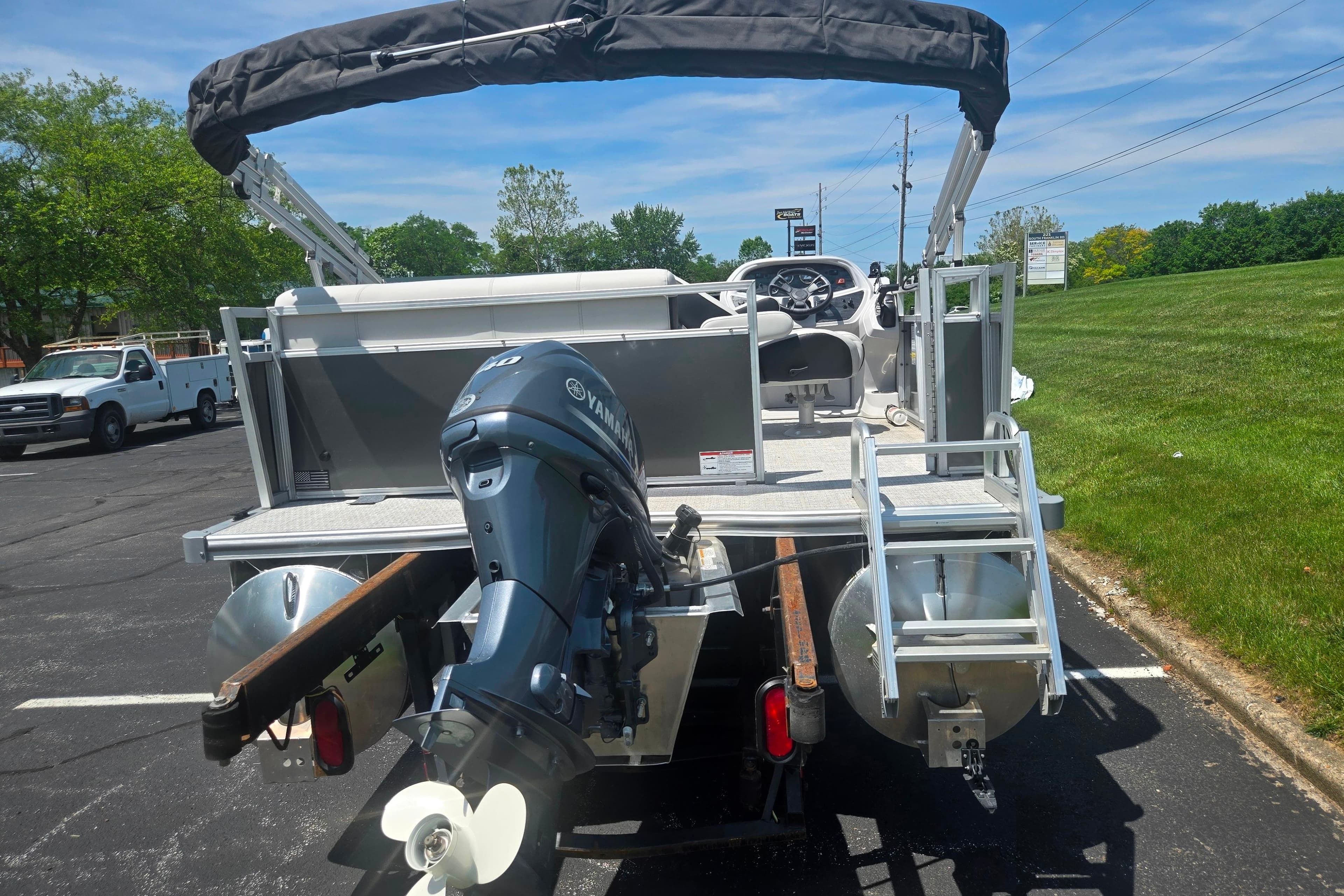 2025 Trifecta 16FC pontoon boat with Yamaha outboard motor, parked on asphalt.