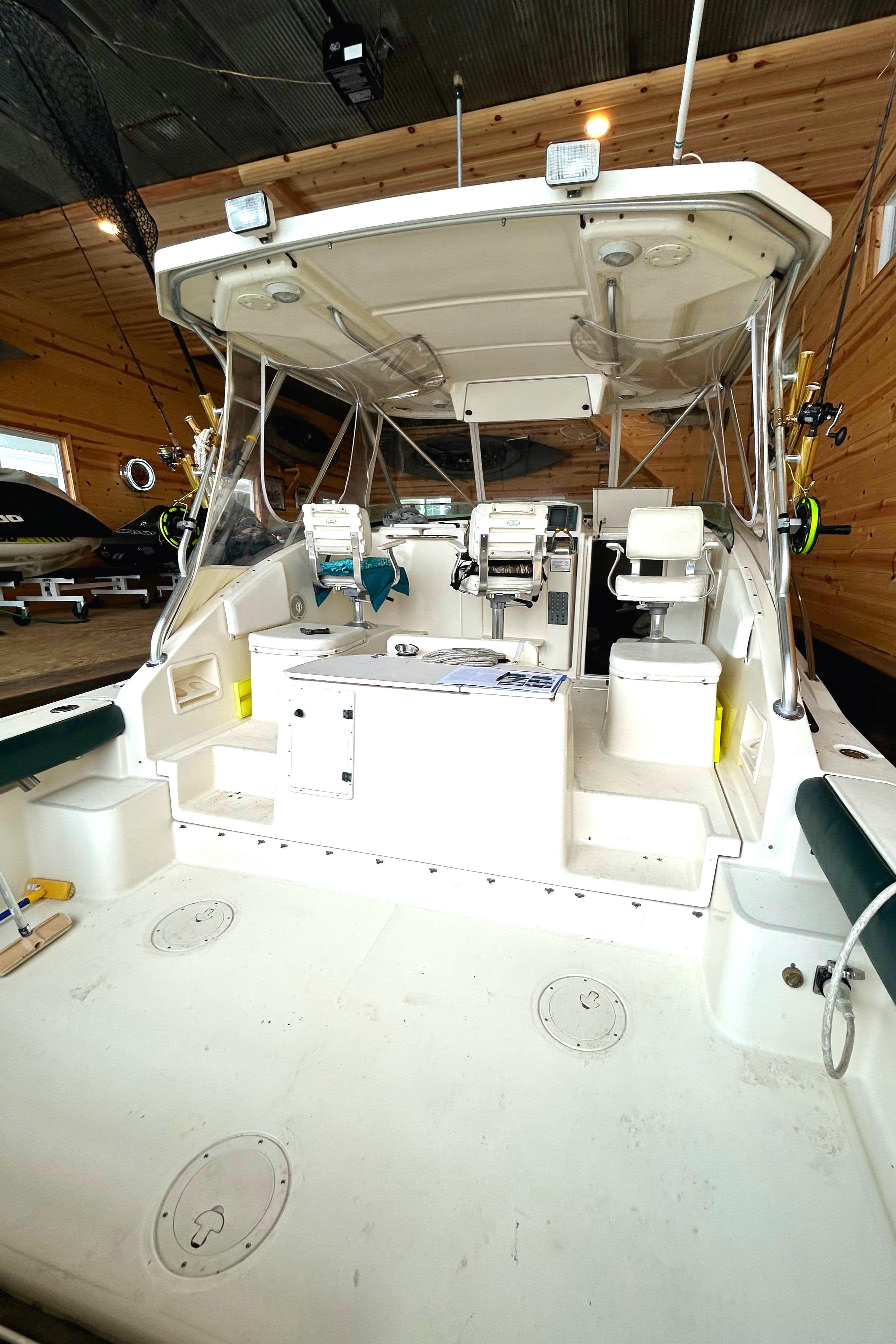 1998 Pursuit 3000 Offshore boat interior with fishing gear and seating.