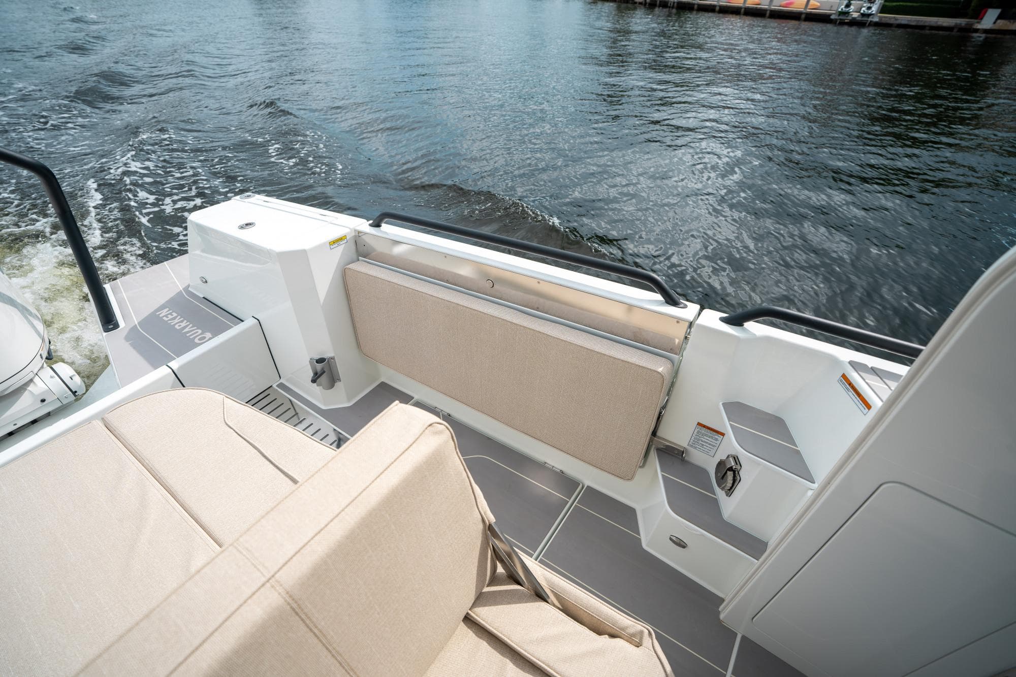 2025 Quarken 35 Sport Tourer boat interior with beige seating and water view.