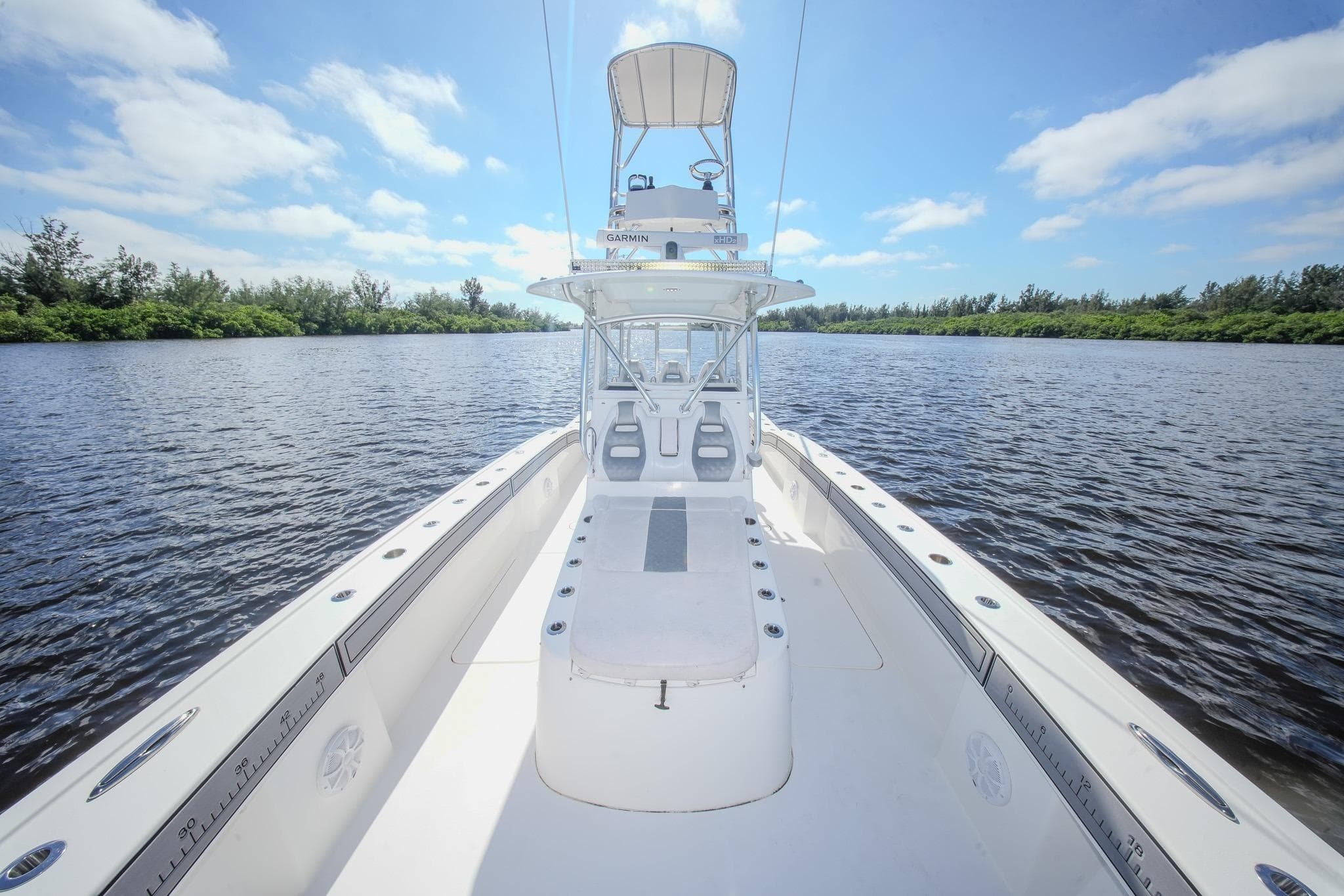 2020 Tideline 365 Offshore boat on calm water under a clear blue sky.