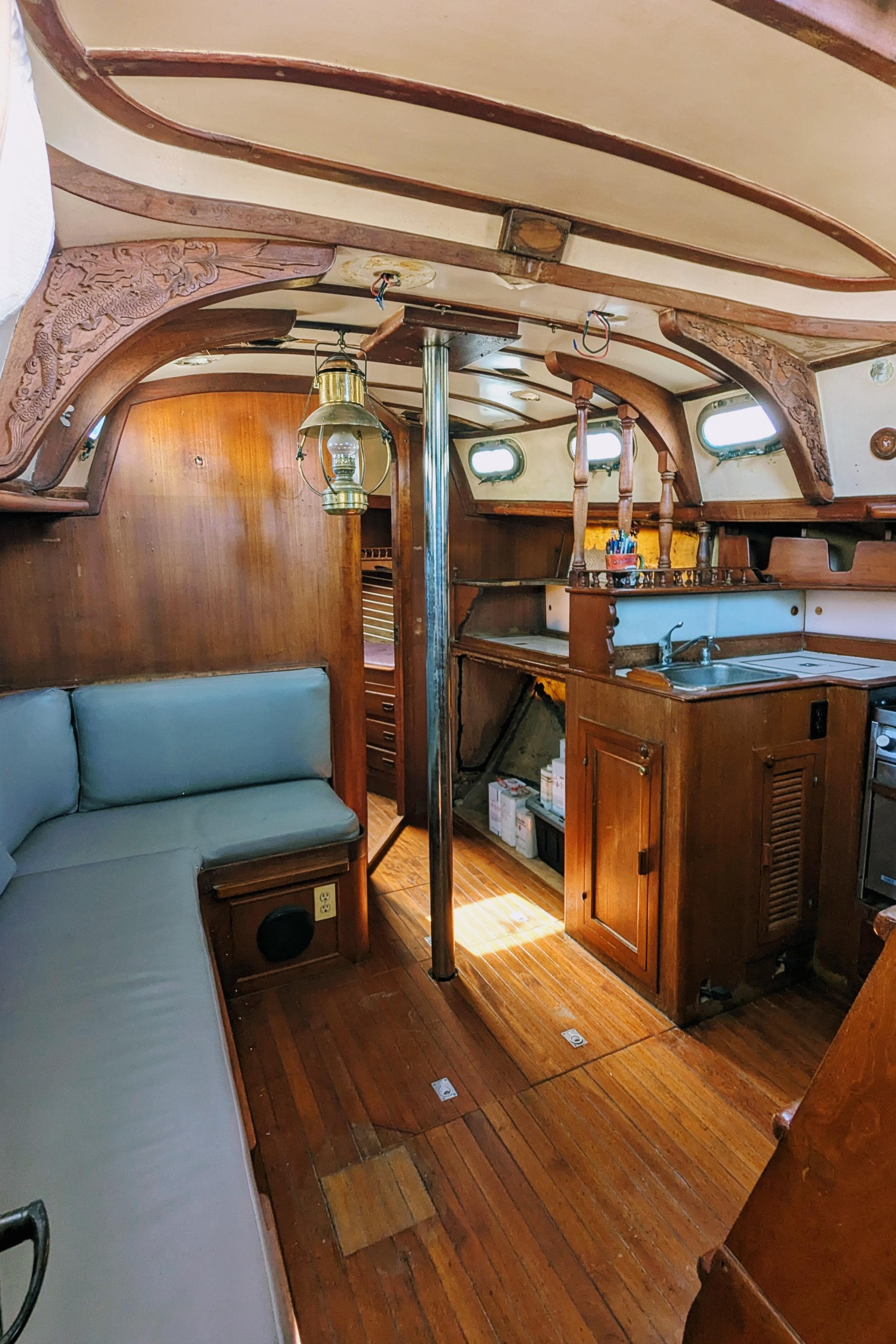 1976 Ta Chiao Fantasia 35 sailboat interior with wood finish and cozy seating area.