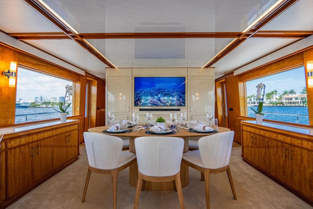 Luxurious dining area on a 2001 Intermarine Raised Pilothouse yacht with waterfront views.