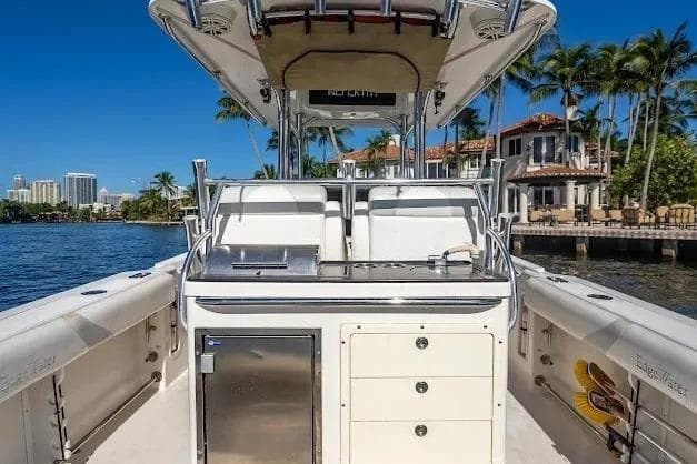 Edgewater 318CC 2010 boat interior with storage, set against a waterfront backdrop.