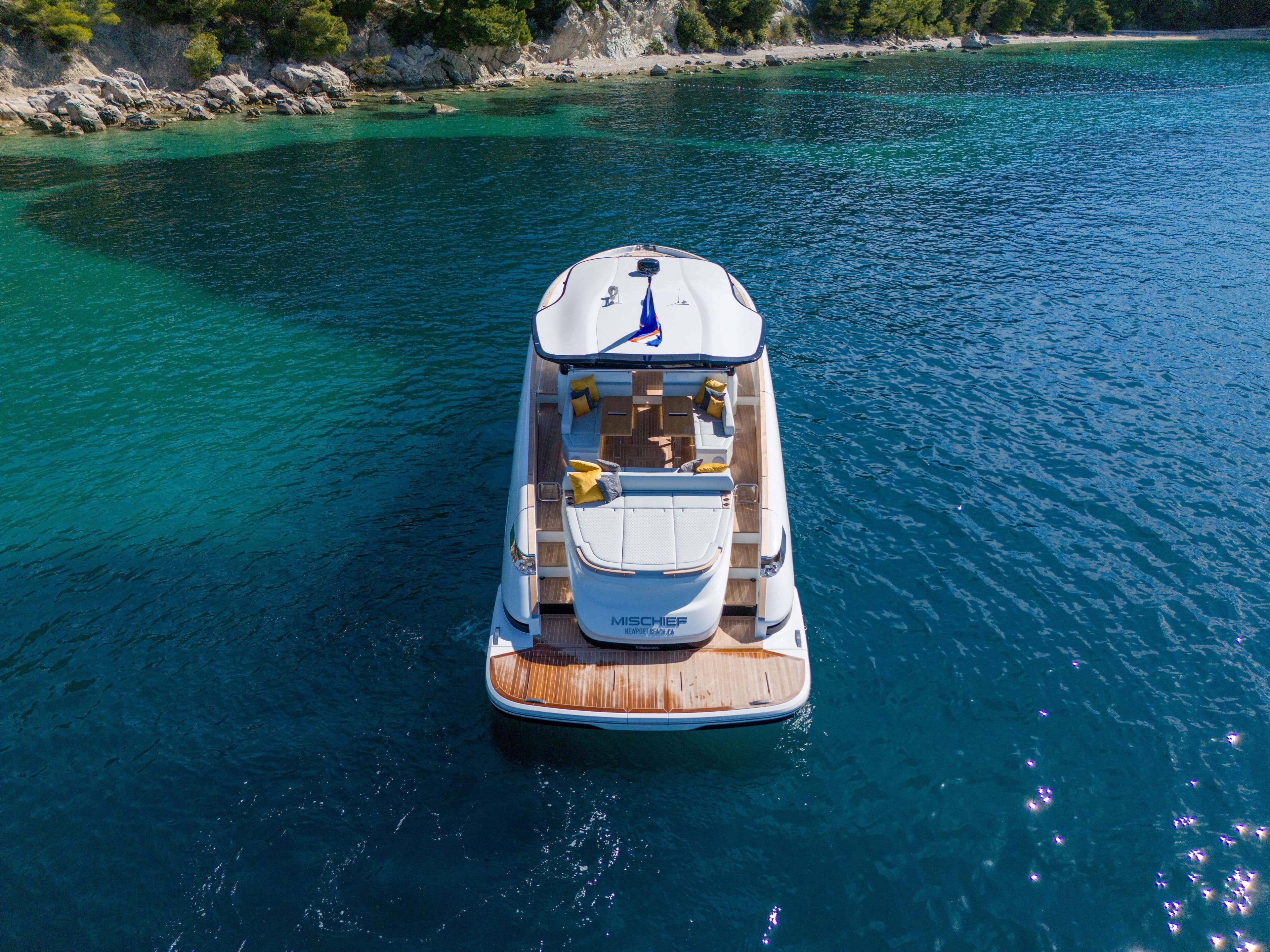 2025 Solaris Power 60 Open yacht on clear blue water, rear view.