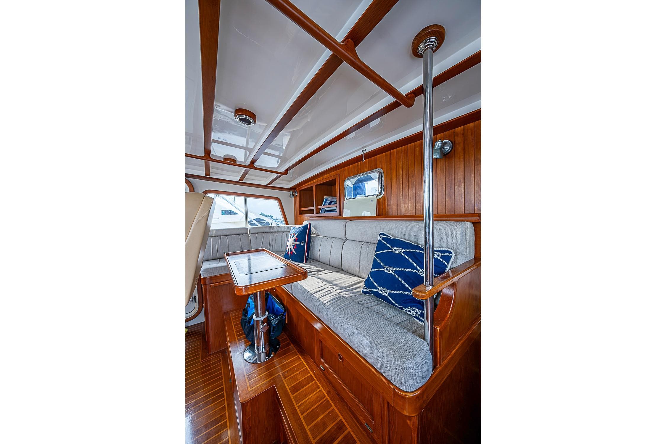 Interior of 2008 Kadey-Krogen 48 North Sea yacht with wooden finish and cushioned seating.