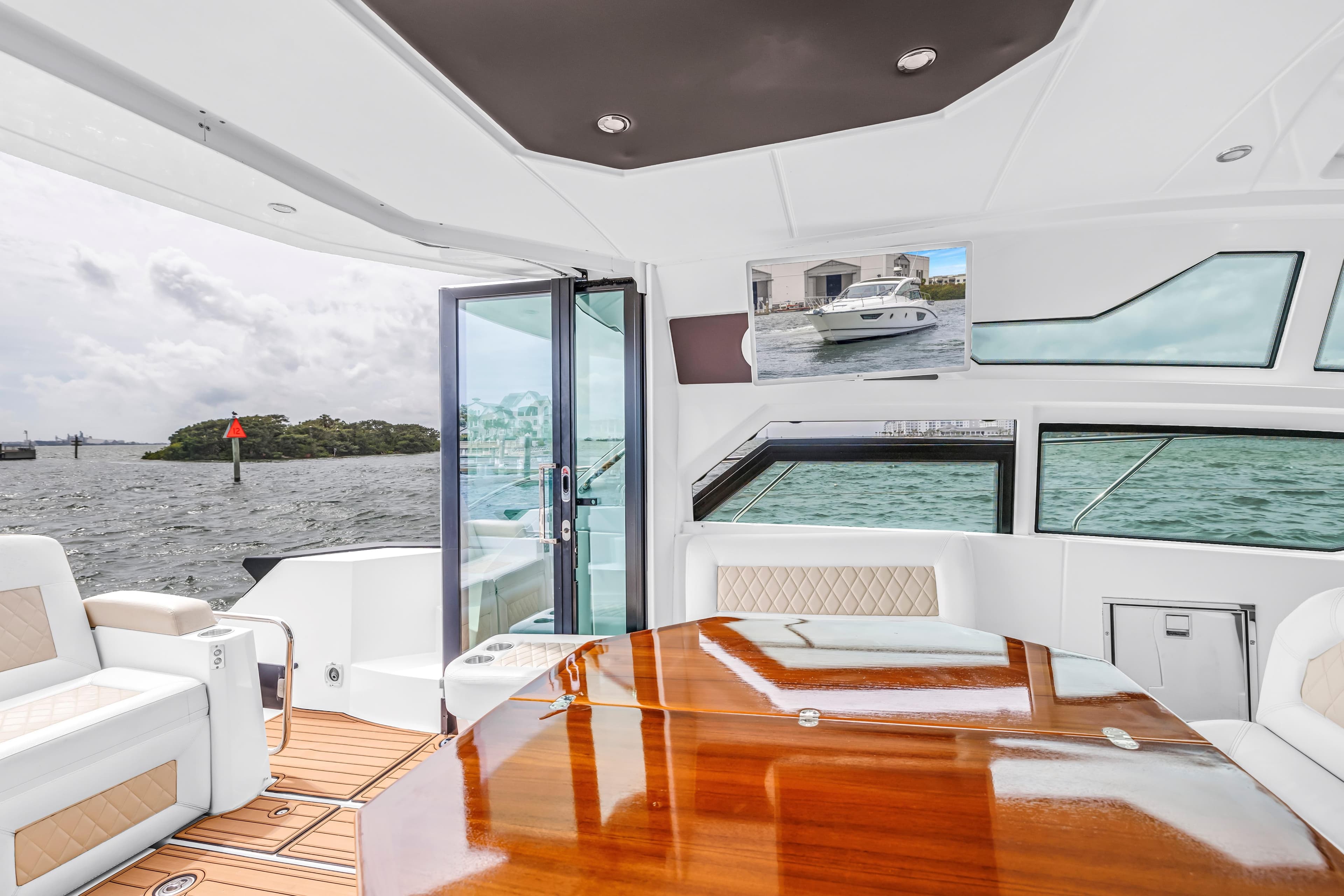 Luxurious interior of 2019 Beneteau Gran Turismo 46 yacht with elegant seating and wooden table.
