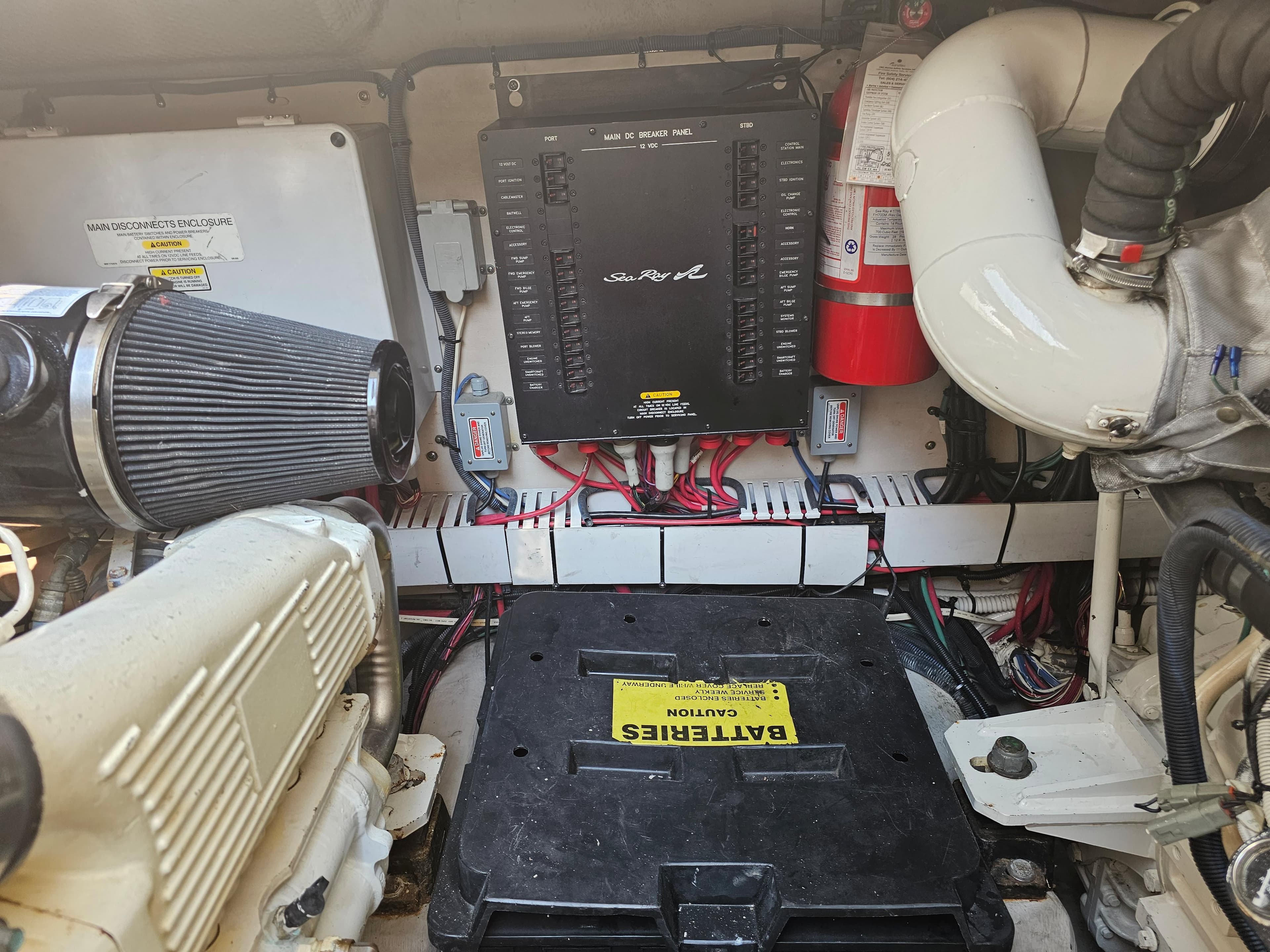 Engine room of 2005 Sea Ray 48 Sundancer with battery and electrical components.