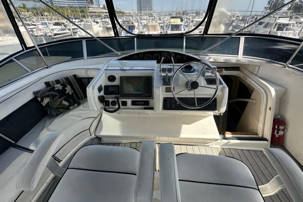 1999 Bayliner 5788 Pilot House Motoryacht helm with steering wheel and navigation equipment.
