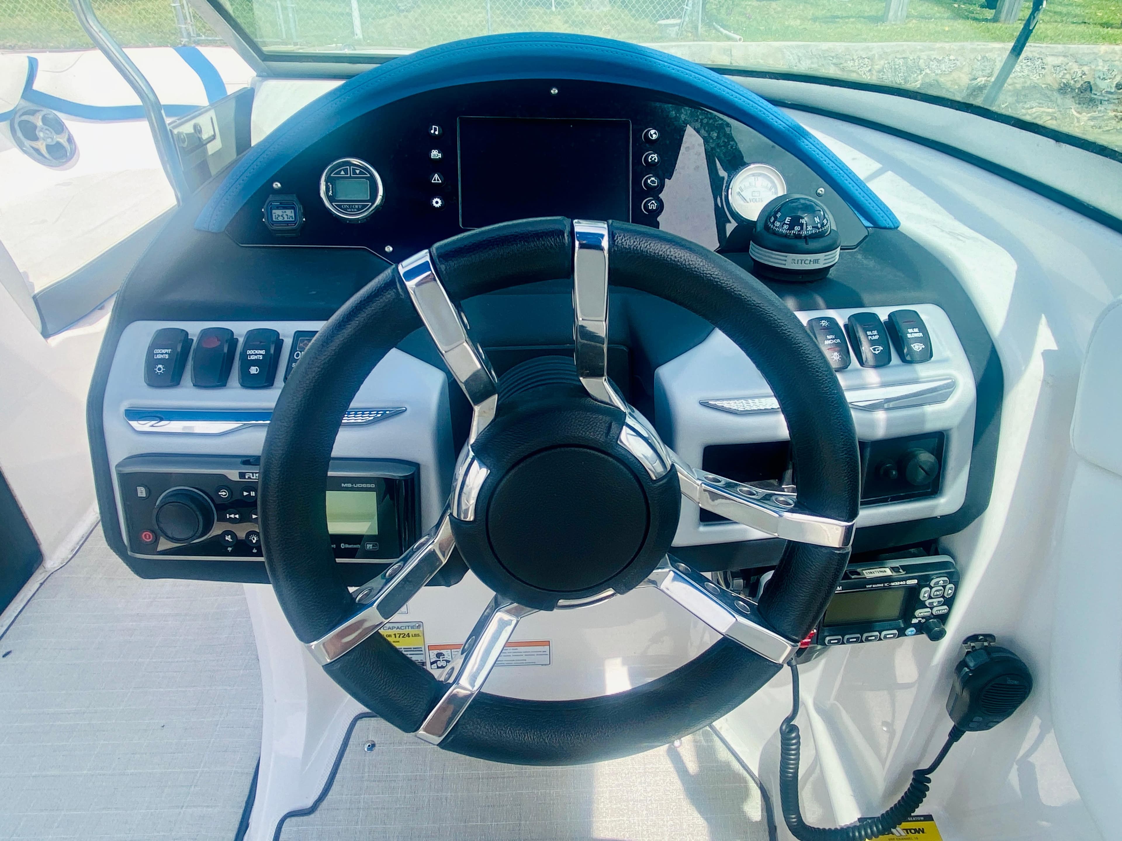 2016 Regal 22 FasDeck boat dashboard with steering wheel and control panel.