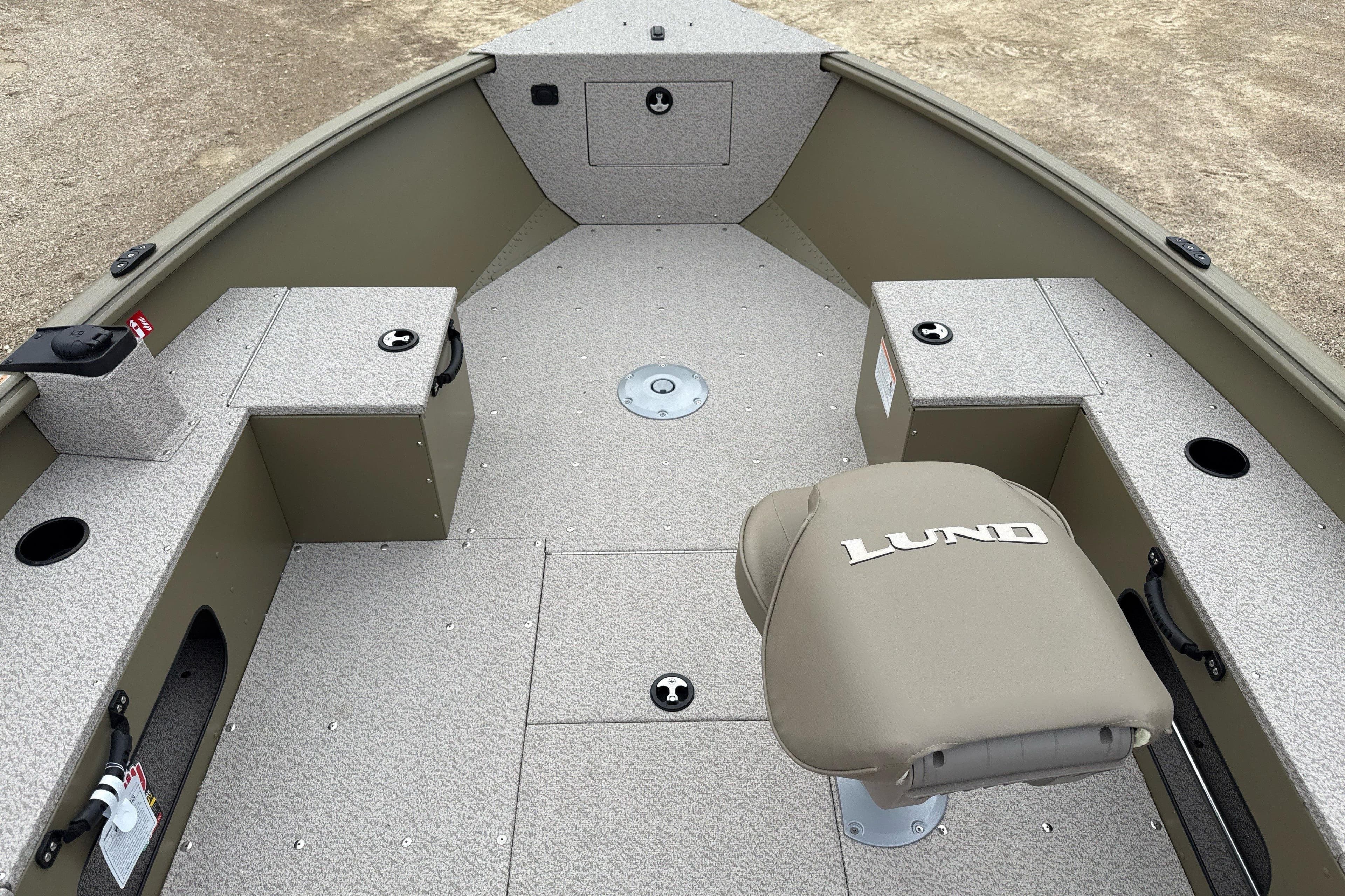 2026 Lund 1675 Alaskan Tiller boat interior with seating and storage compartments.