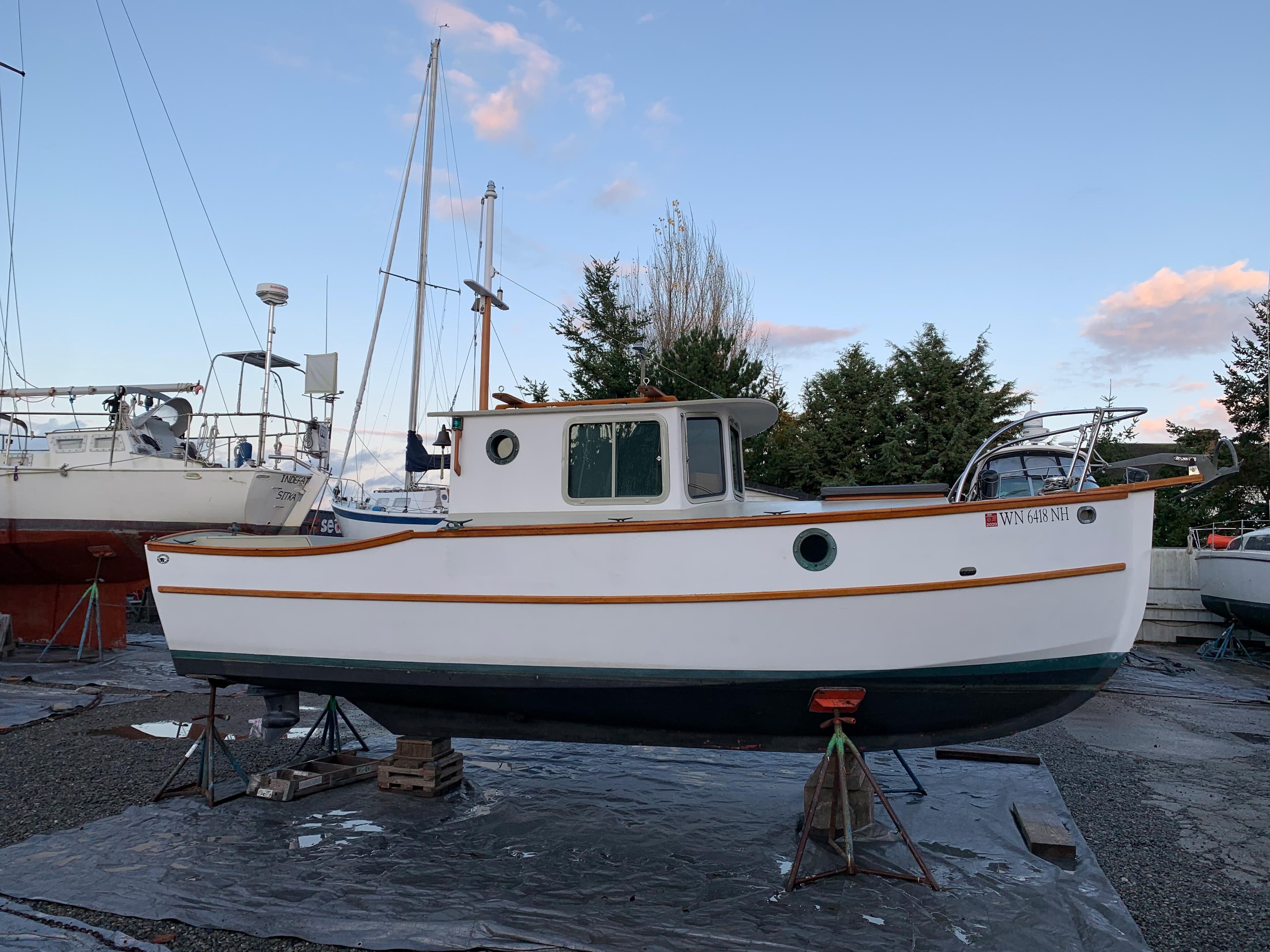 Devlin Surf Scoter 1992 boat on stands, surrounded by other vessels, under a clear sky.