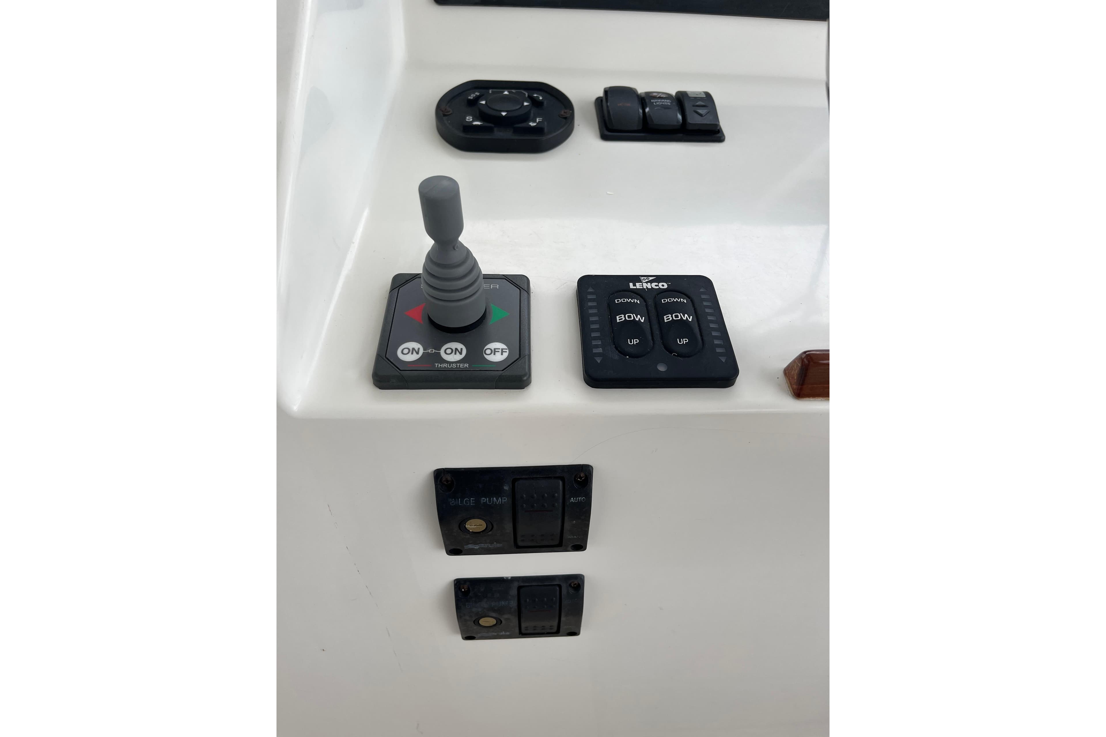 Control panel of a 2009 MJM 29z Express boat with joystick and switches.